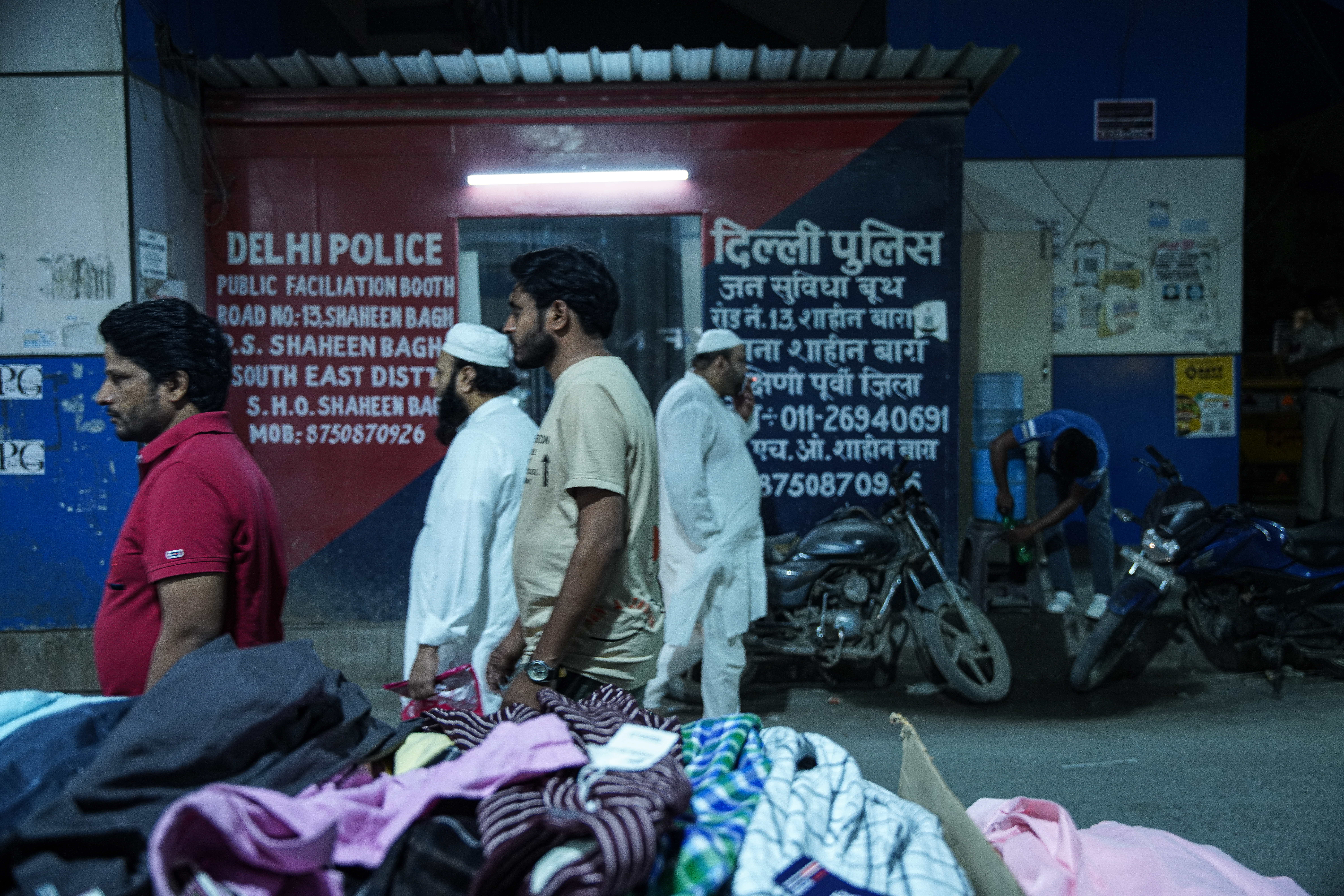 People walk past a police booth set up at the site where women protested against the citizenship law in 2019. [Meer Faisal/Al Jazeera]