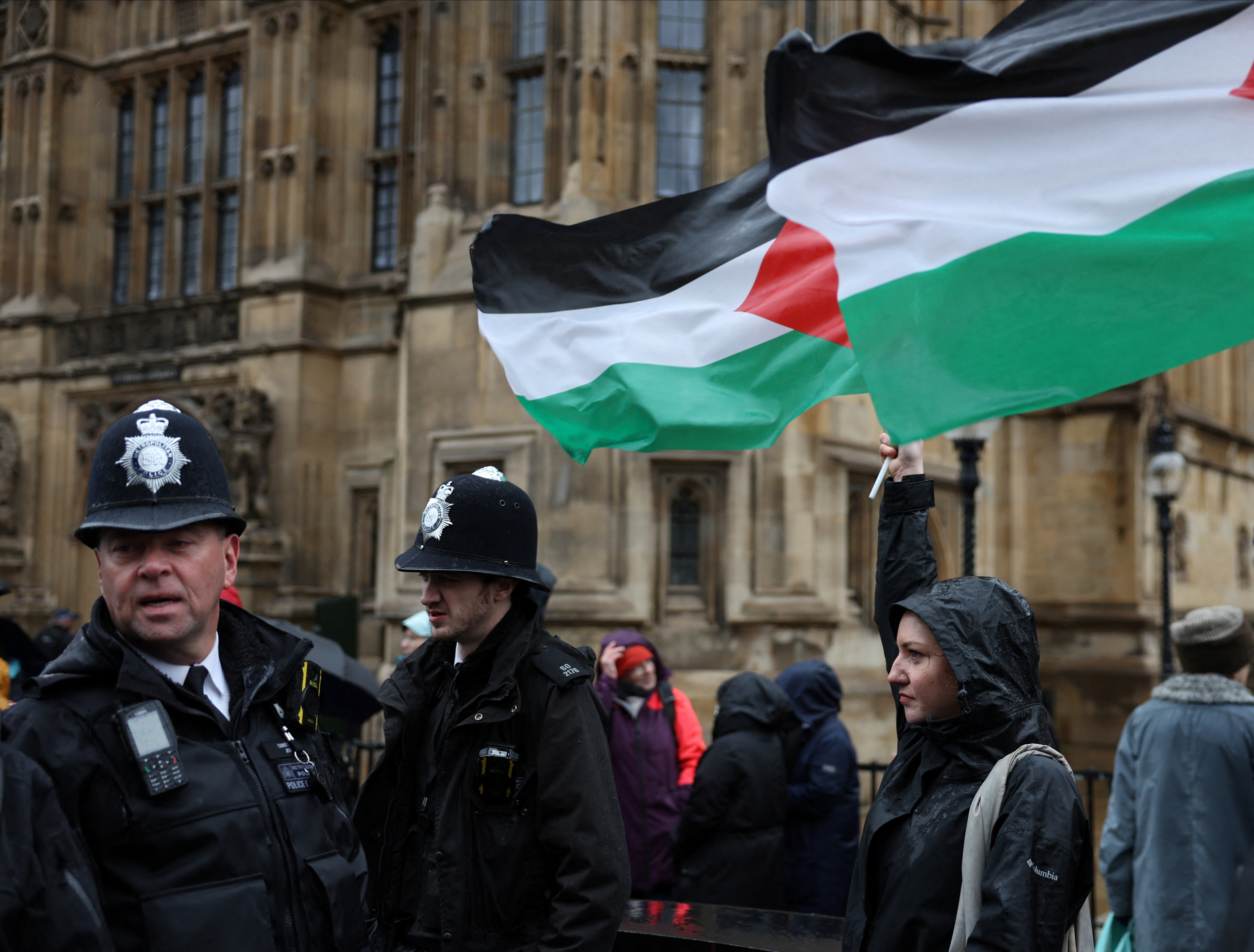 Police officers keep watch as campaigners queue to lobby MPs in Parliament ahead of a debate to hold a vote for a ceasefire in Gaza, amid the ongoing conflict between Israel and the Palestinian Islamist group Hamas, in London, Britain, February 21, 2024. REUTERS/Isabel Infantes