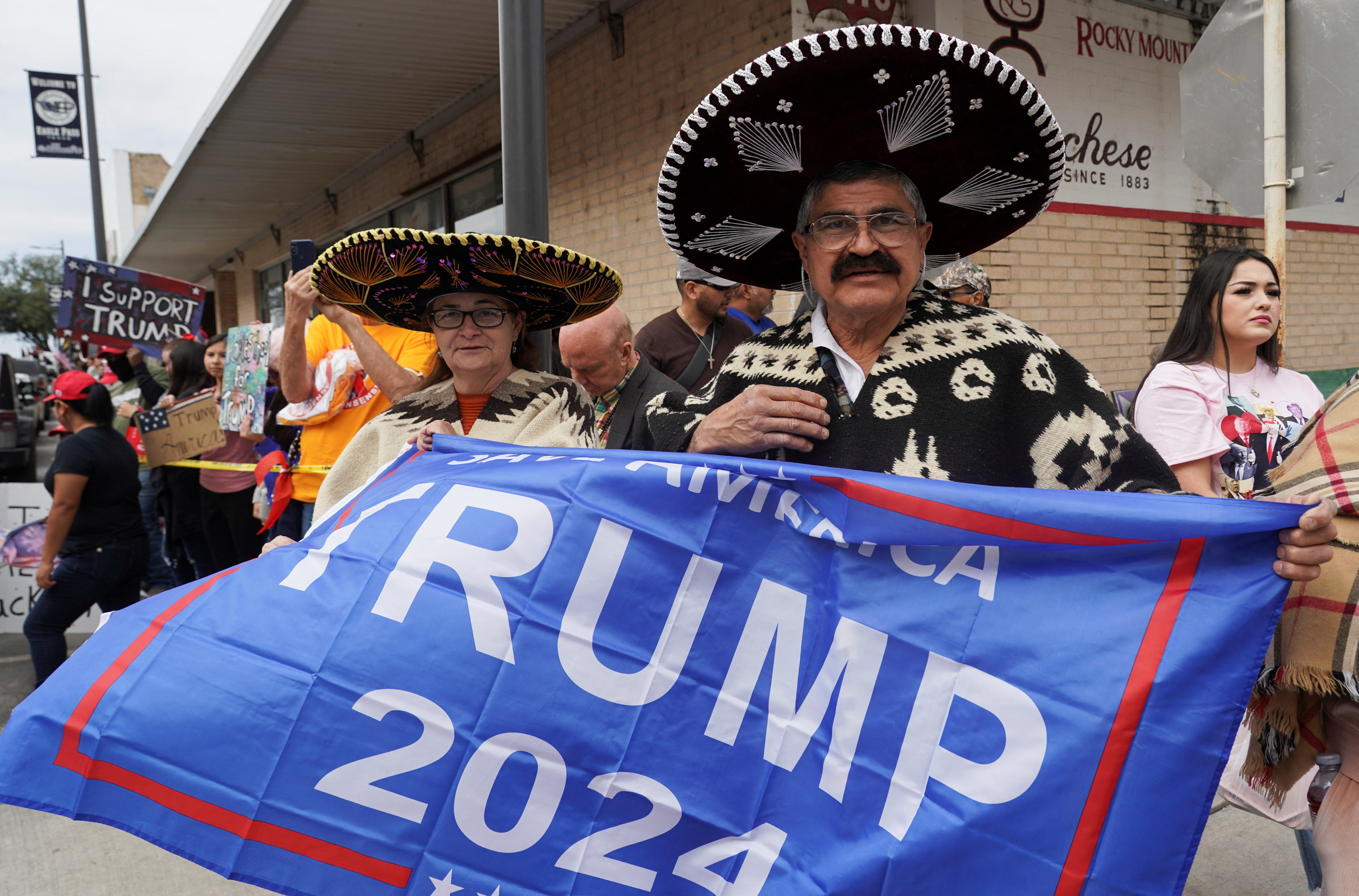A supporter in a sombrero waves a Trump 2024 flag in Texas.