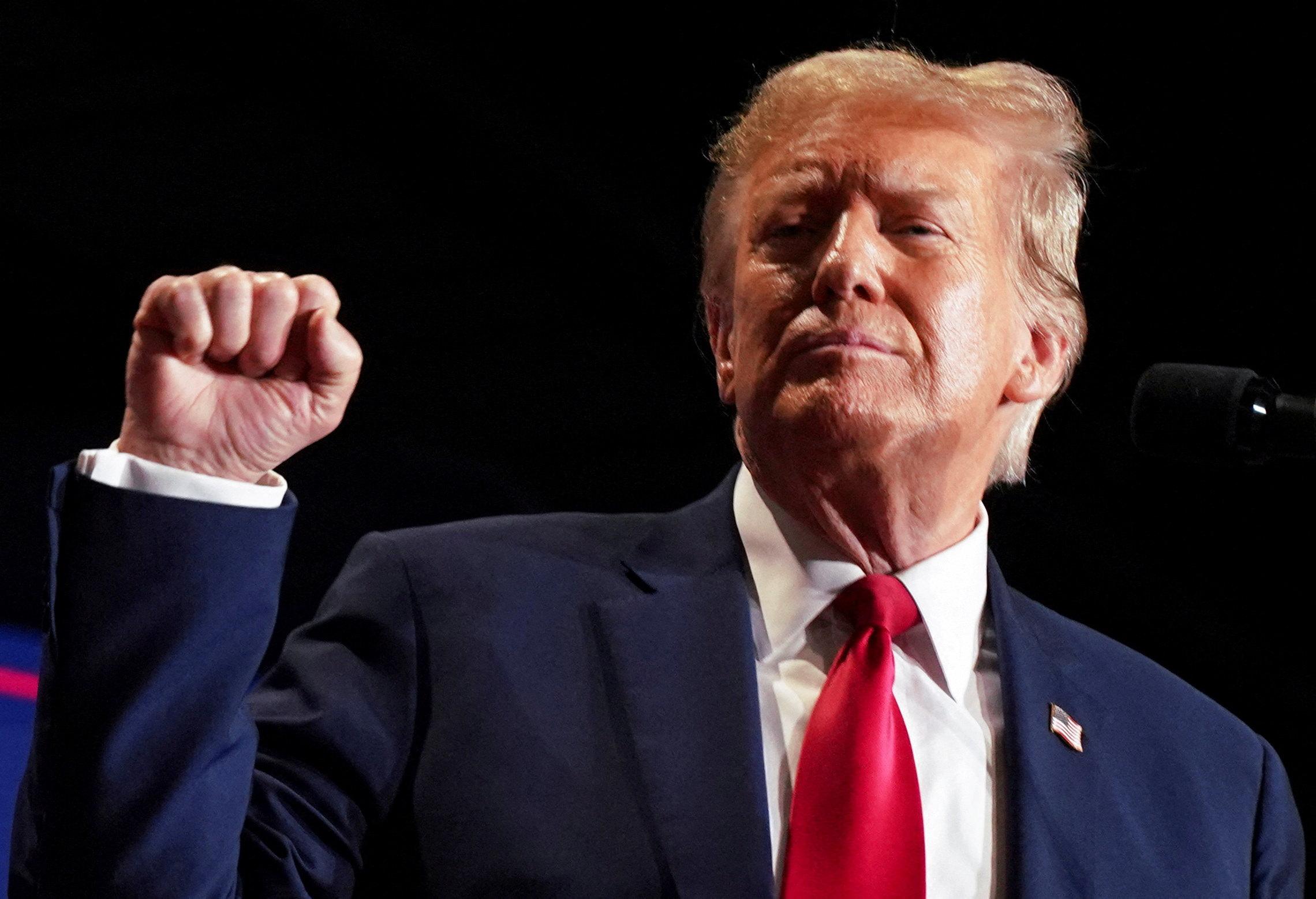 Donald Trump holds his fist in the air