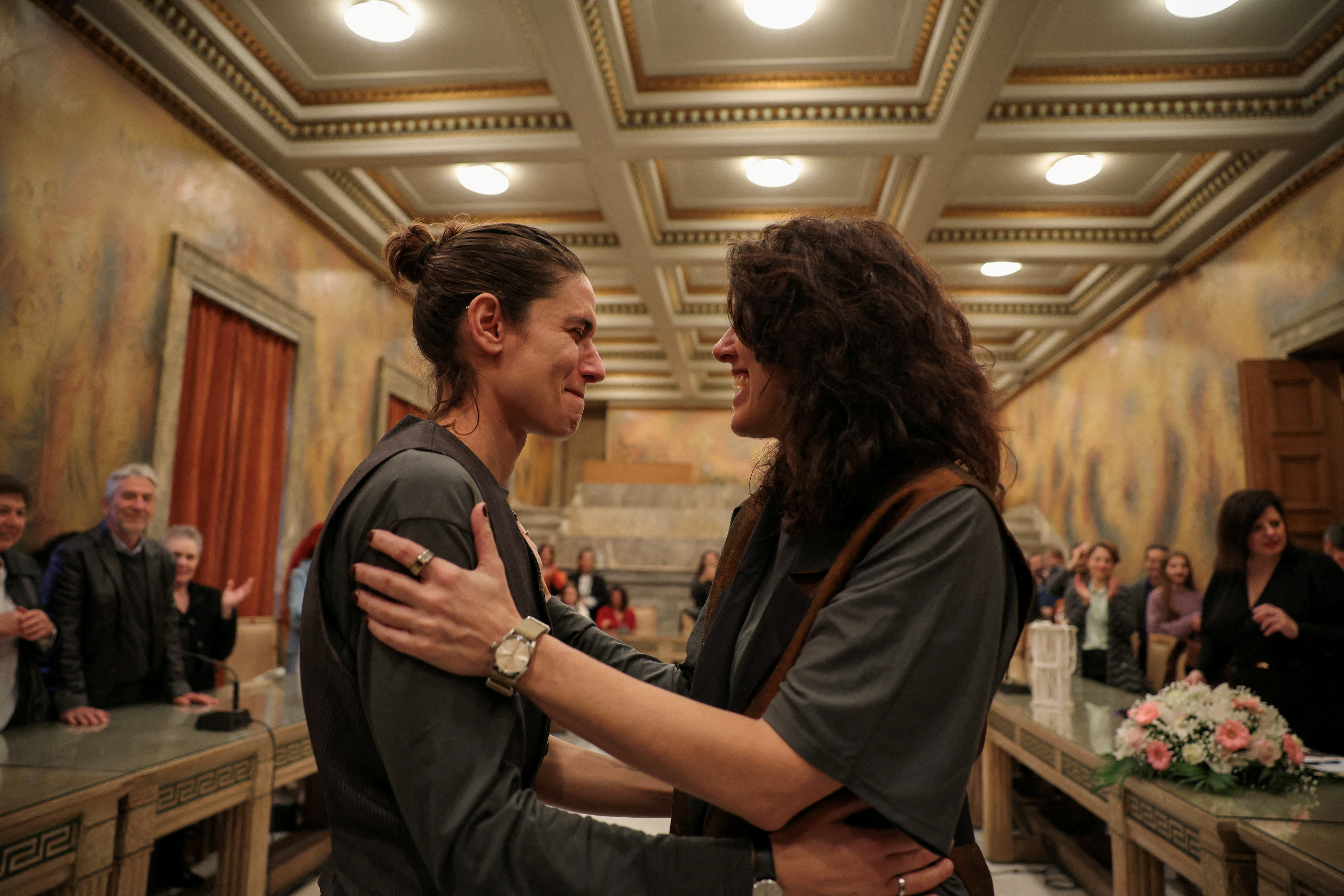 Danai Deligiorgi, 37, and Alexia Beziki, 43, one of the first couples to marry after the passing of legislation for same-sex marriages, embrace after their wedding ceremony at the Athens Town Hall in Athens, Greece, March 7