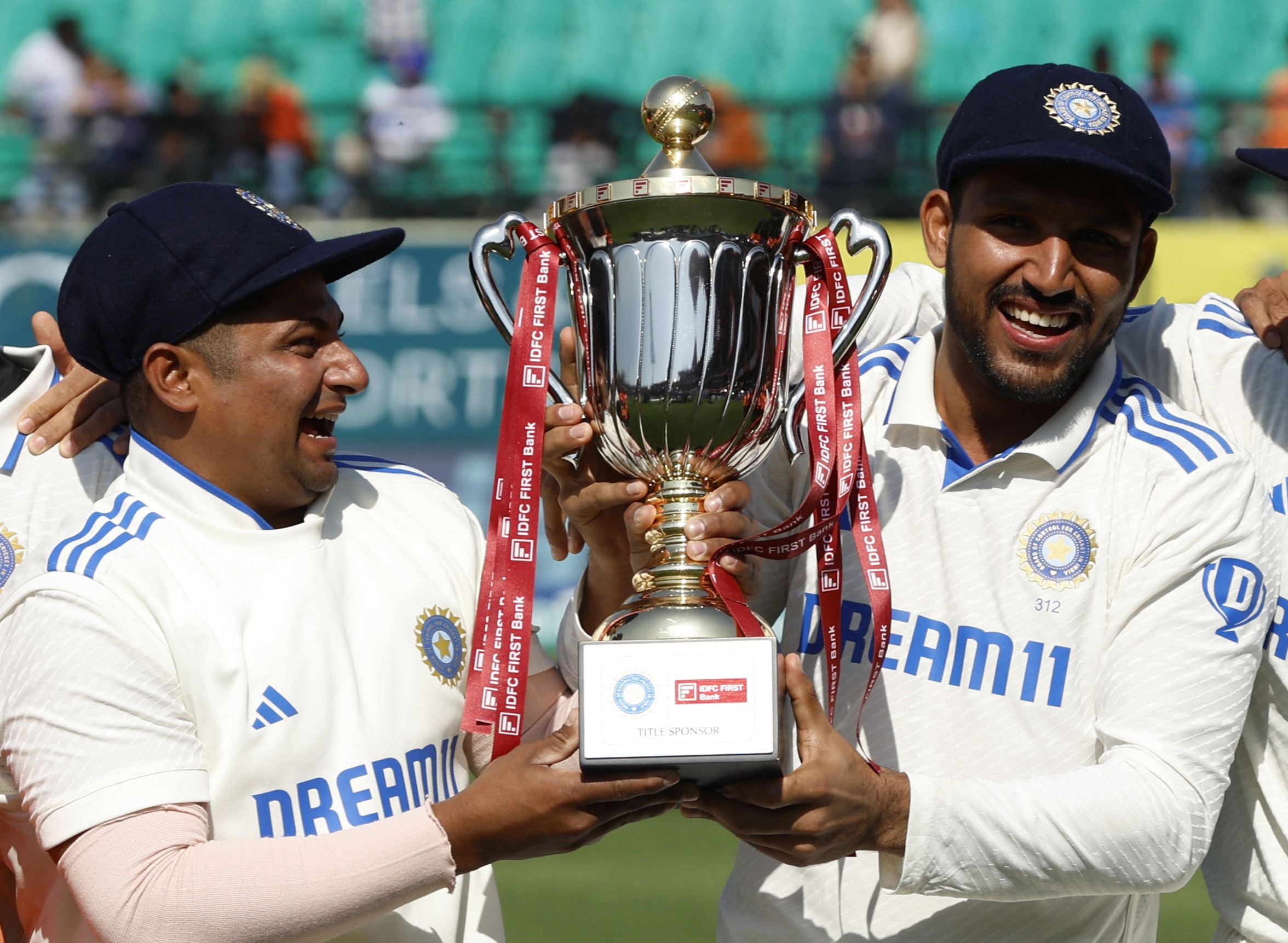 Cricket - Fifth Test - India v England - Himachal Pradesh Cricket Association Stadium, Dharamshala, India - March 9, 2024 India's Sarfaraz Khan and Dhruv Jurel lift the trophy and celebrate after winning the Test series REUTERS/Adnan Abidi