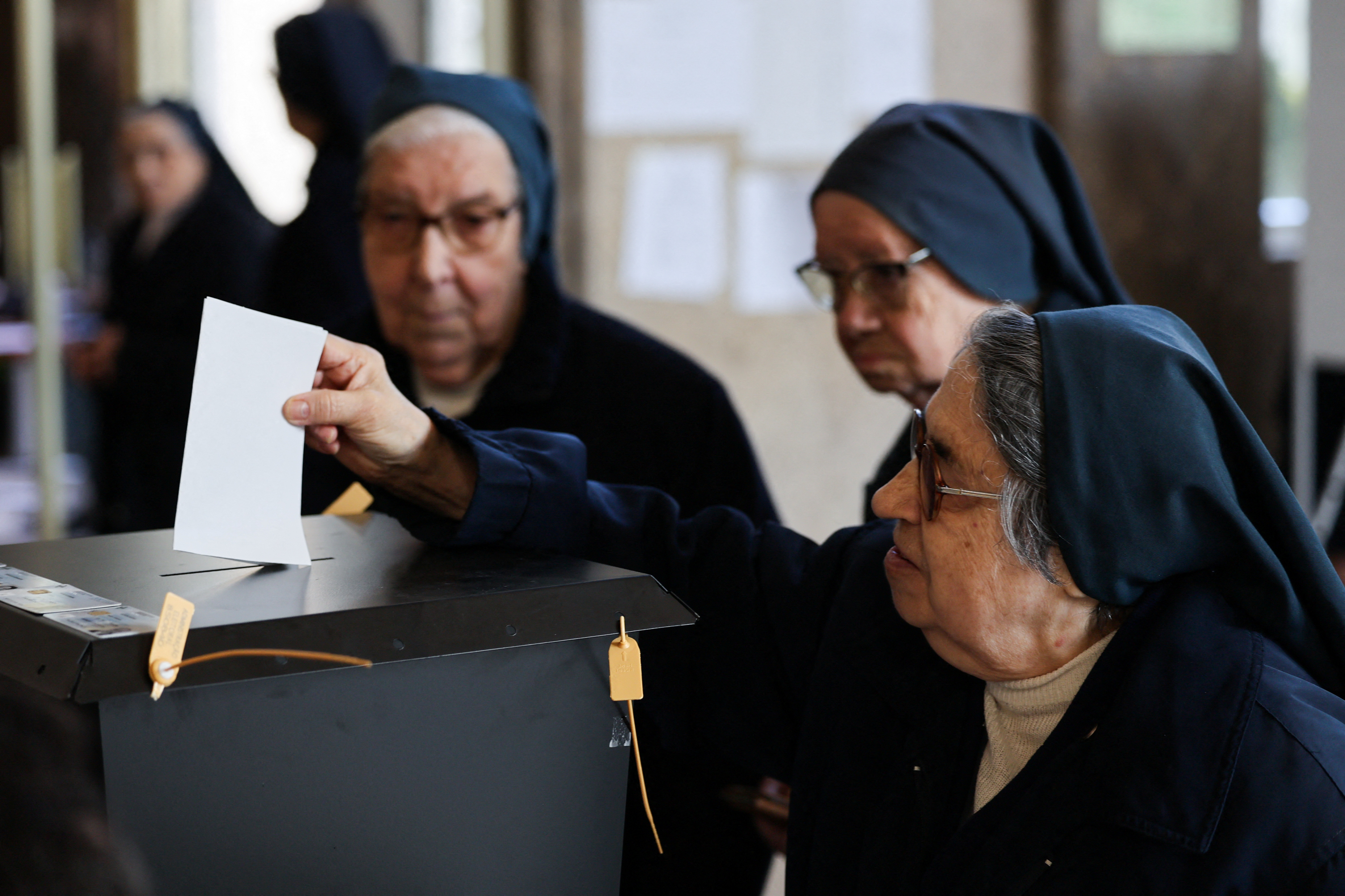 A nun casts her ballot at a polling station during the general election in Lisbon, Portugal