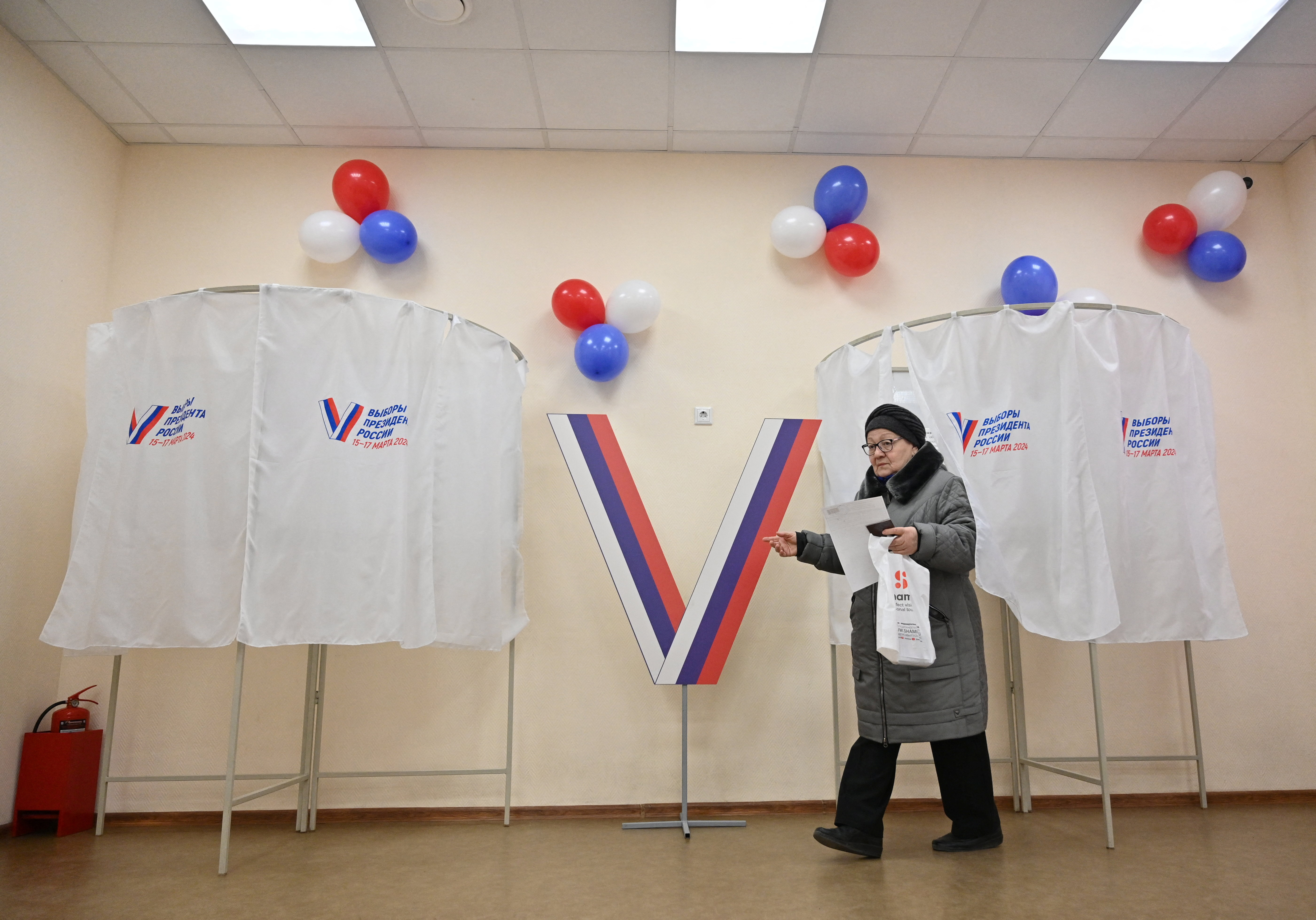 A woman walks to cast her ballot at a polling station during the presidential election in Rostov-on-Don, Russia