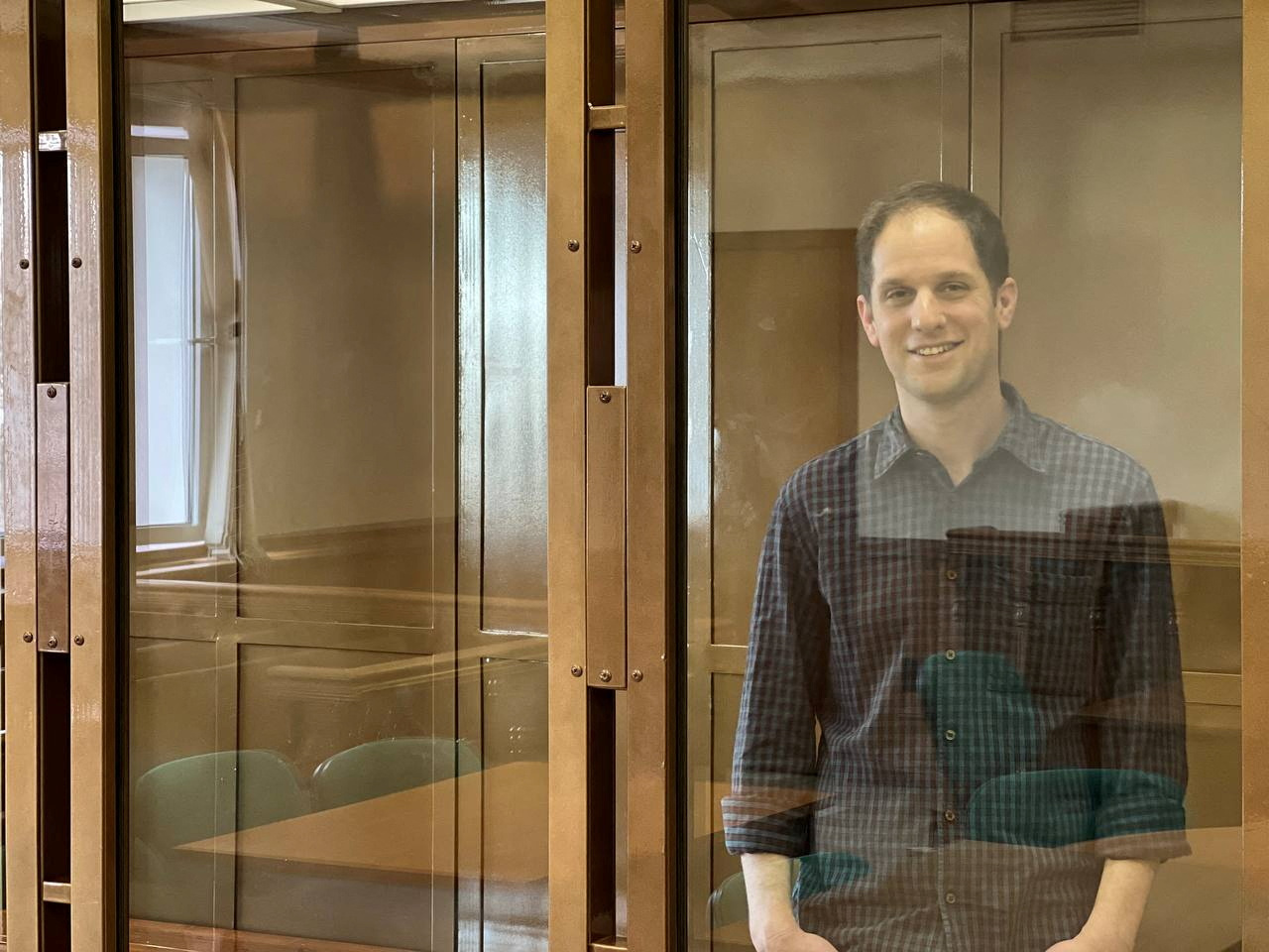 Wall Street Journal reporter Evan Gershkovich, who is in custody on espionage charges, stands behind a glass wall of an enclosure for defendants as he attends a court hearing to consider extending his detention in Moscow, Russia, March 26, 2024. Moscow City Court's Press Office/Handout via REUTERS ATTENTION EDITORS - THIS IMAGE HAS BEEN SUPPLIED BY A THIRD PARTY. NO RESALES. NO ARCHIVES. MANDATORY CREDIT.