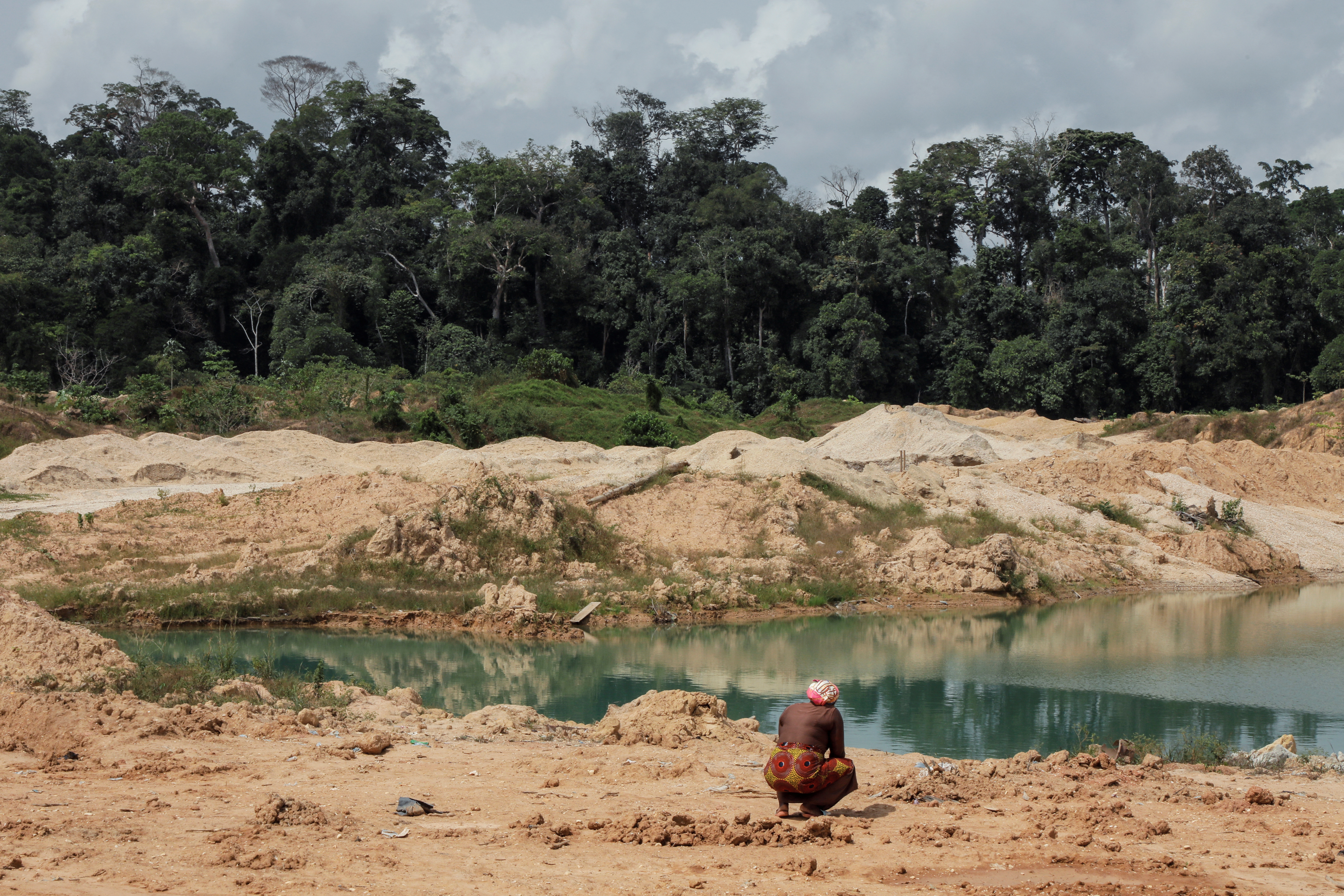Janet Gyamfi, 52, a cocoa farmer, visits her cocoa plantation destroyed by illegal gold mining in the Samreboi community in the Western Region, Ghana, February 26