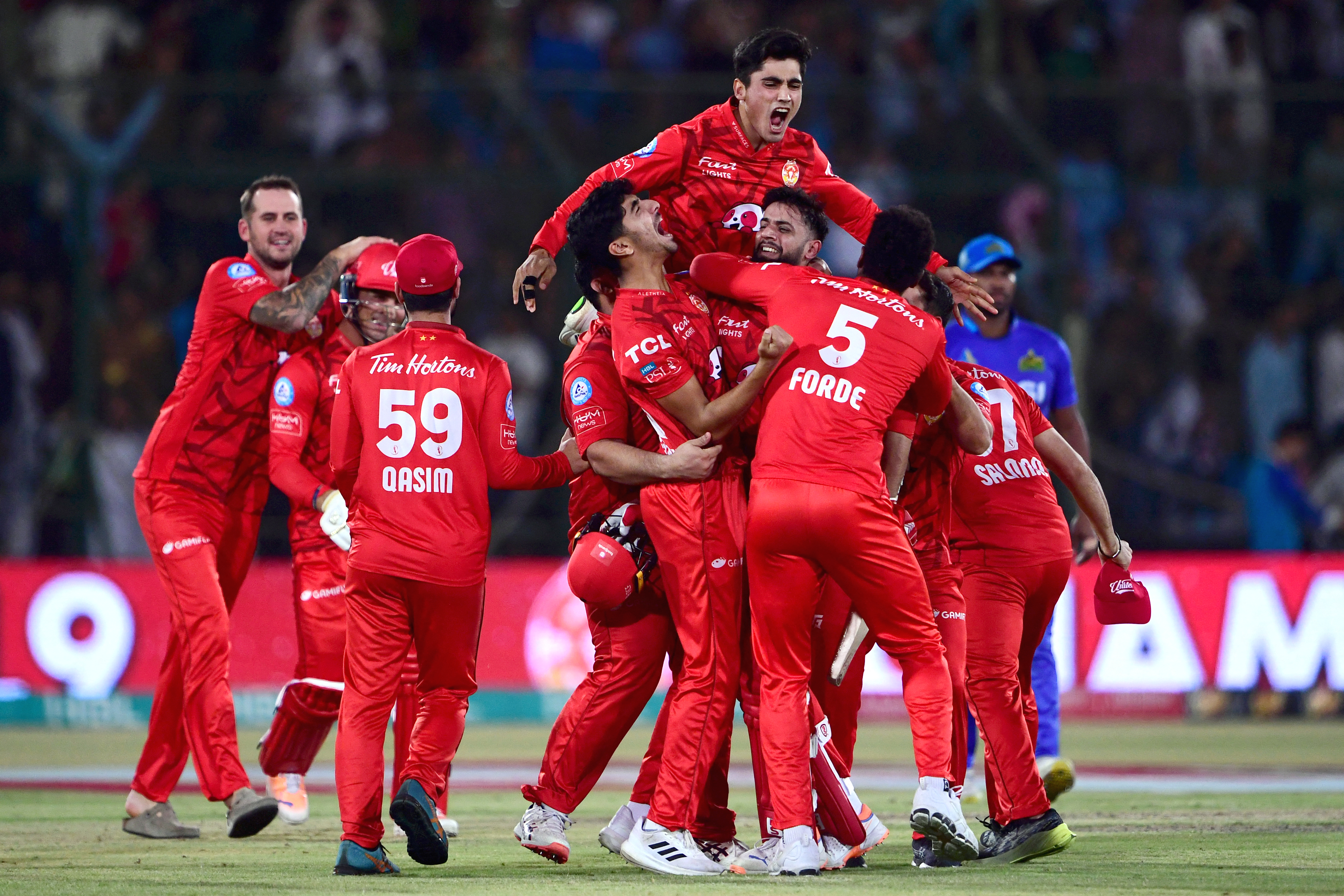 Islamabad United's players celebrate their victory at the end of the Pakistan Super League (PSL) Twenty20 cricket final match between Islamabad United and Multan Sultans