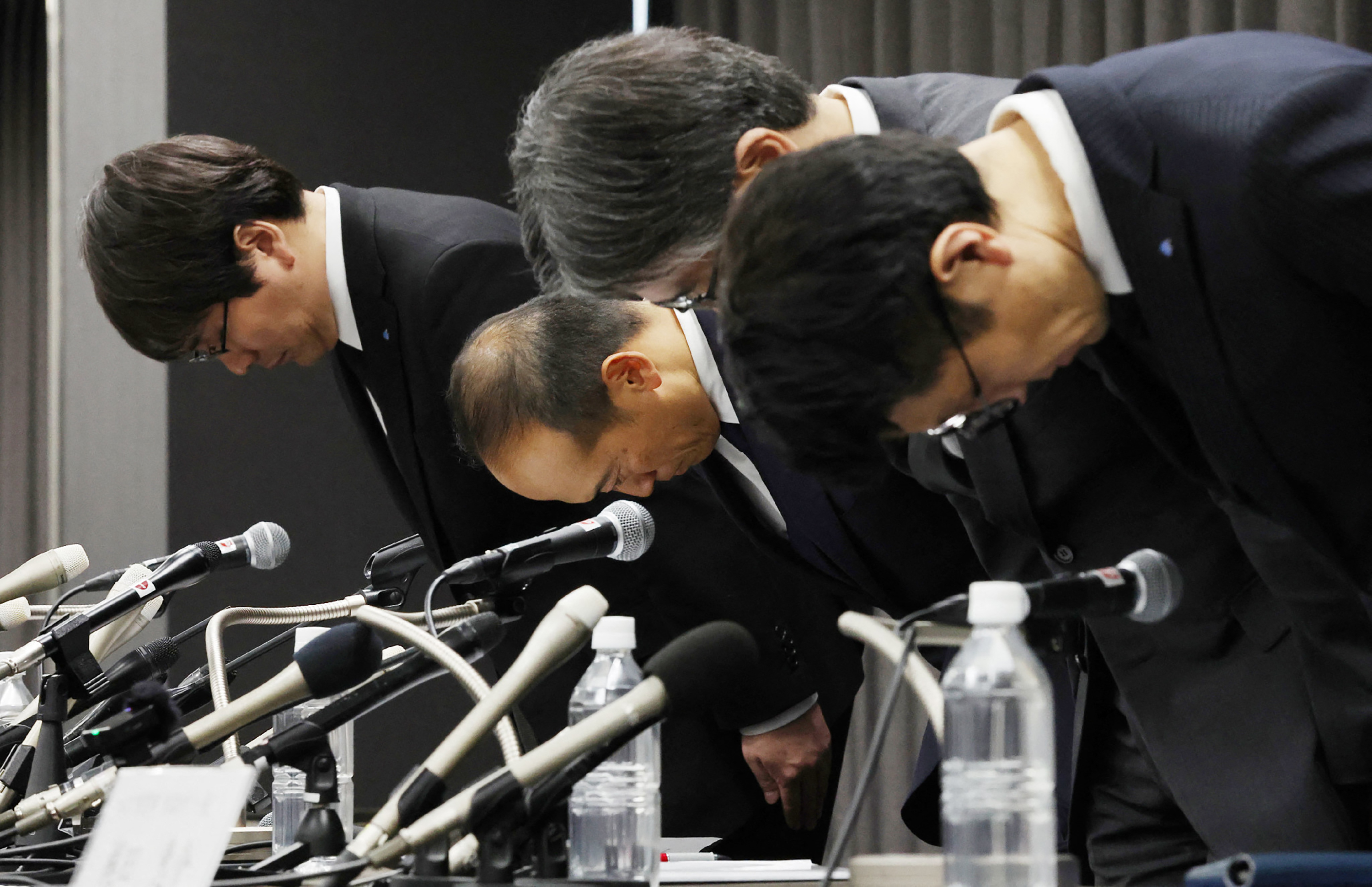 Officials of Kobayashi bow in apologies at a press conference
