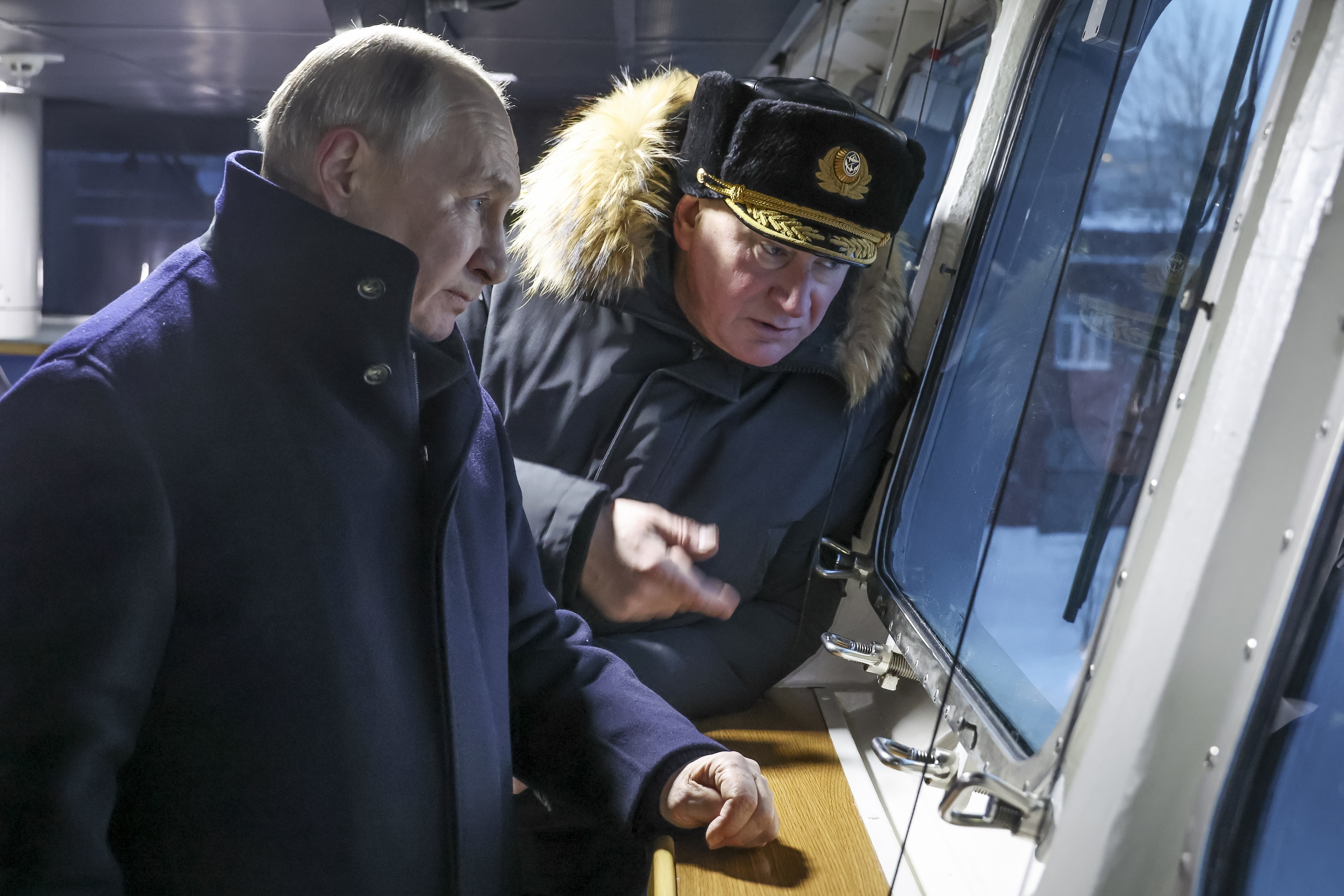 Russian President Vladimir Putin, left, and Admiral Nikolai Yevmenov, Commander-in-Chief of the Russian Navy visit the newest frigate "Admiral of the fleet Kasatonov" on the occasion of a flag-raising ceremony for newly-built nuclear submarines at the Sevmash shipyard in Severodvinsk in Russia's Archangelsk region, Monday, Dec. 11, 2023. The navy flag was raised on the Emperor Alexander III and the Krasnoyarsk submarines during Monday's ceremony. Putin has traveled to a northern shipyard to attend the commissioning of new nuclear submarines, a visit that showcases the country's nuclear might amid the fighting in Ukraine. (Mikhail Klimentyev, Sputnik, Kremlin Pool Photo via AP)