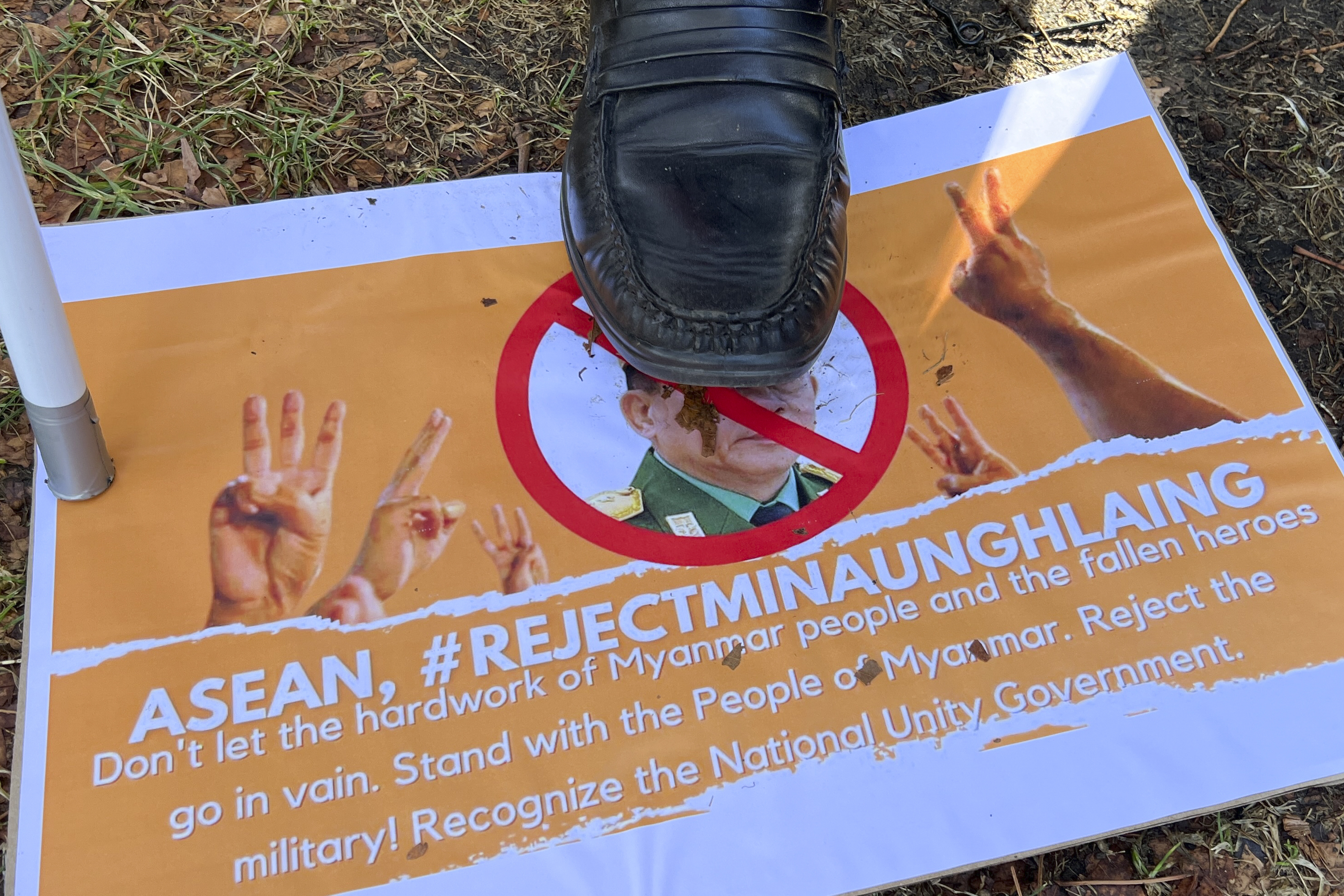 A protester stamps on a picture of Min Aung Hlaing.