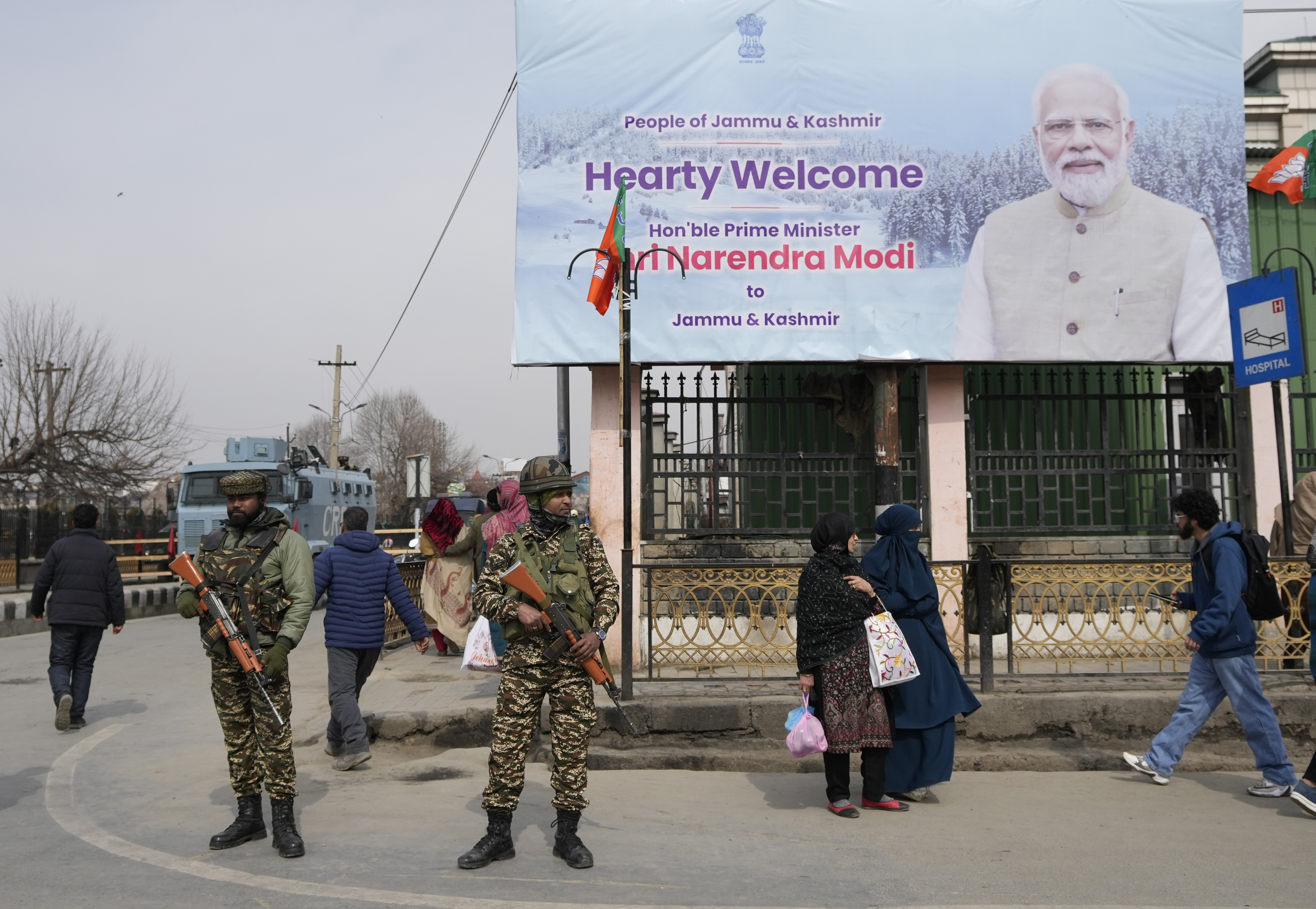 Paramilitary soldiers guard near a billboard ahead of Indian Prime Minister Narendra Modi's visit to Srinagar, Indian controlled Kashmir.