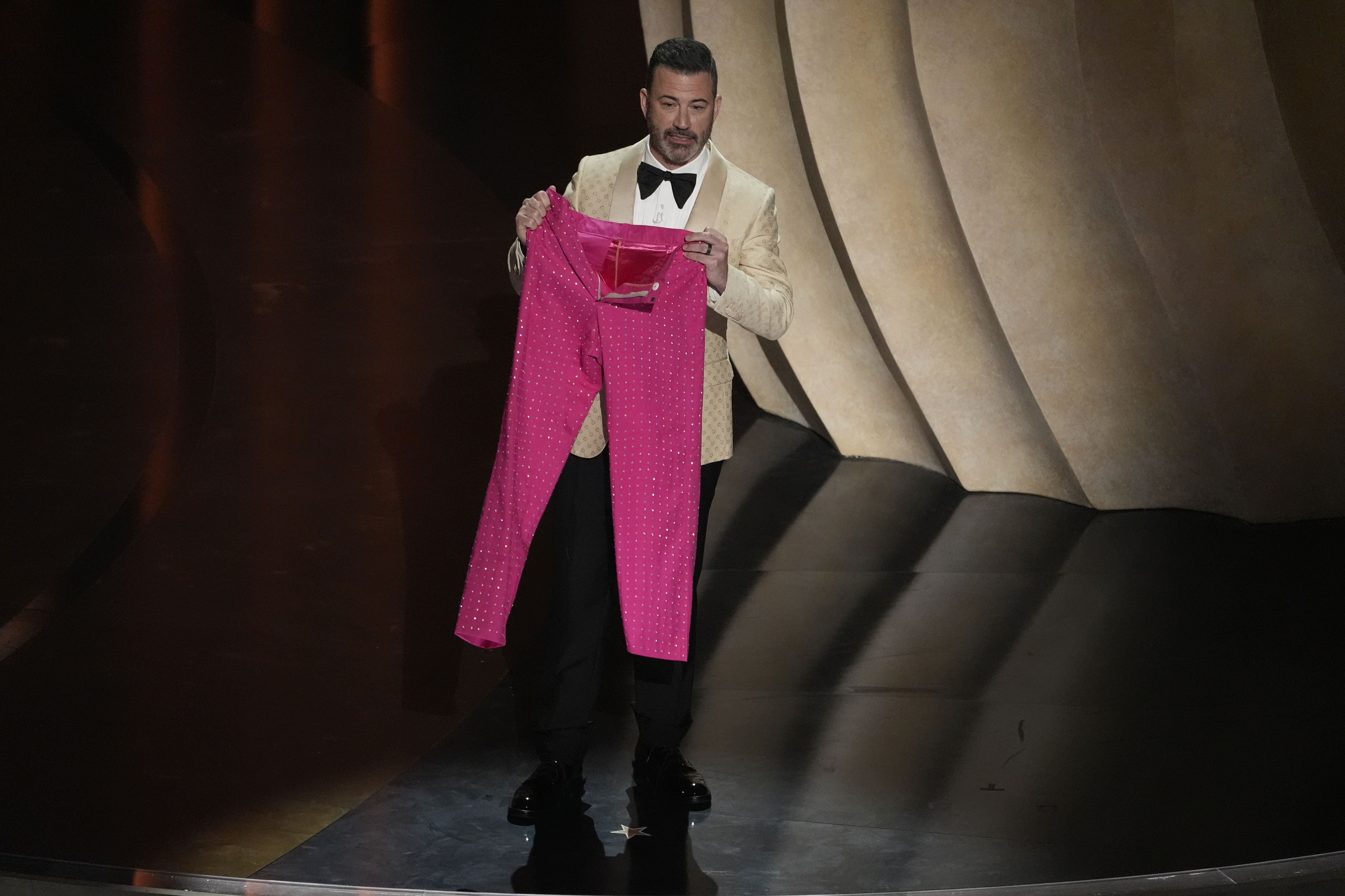 Jimmy Kimmel holds up a pair of pink sparkly pants.