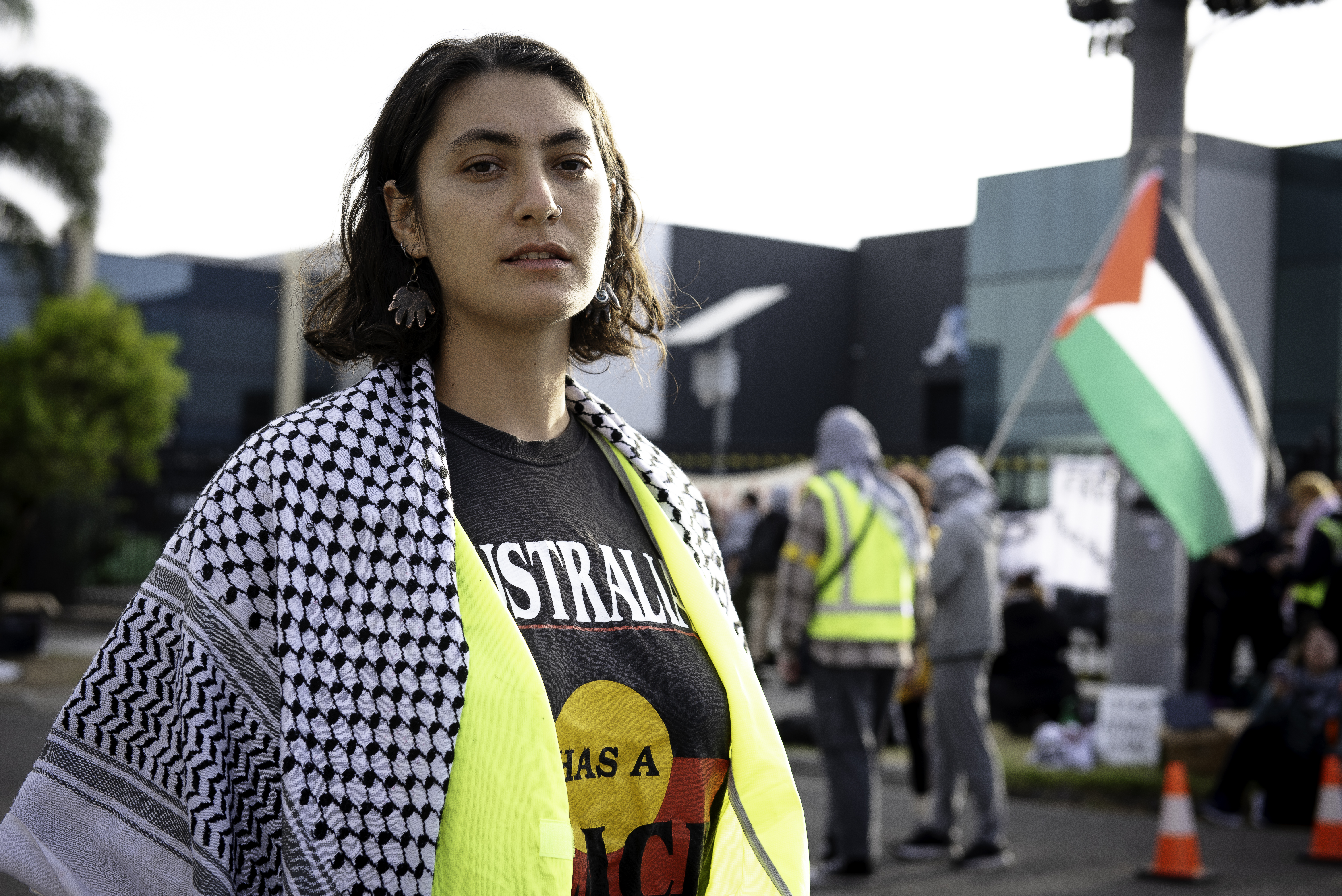 Community organiser Nathalie Farah. She's wearing a Palestinian scarf and a black T-shirt saying Australia. 