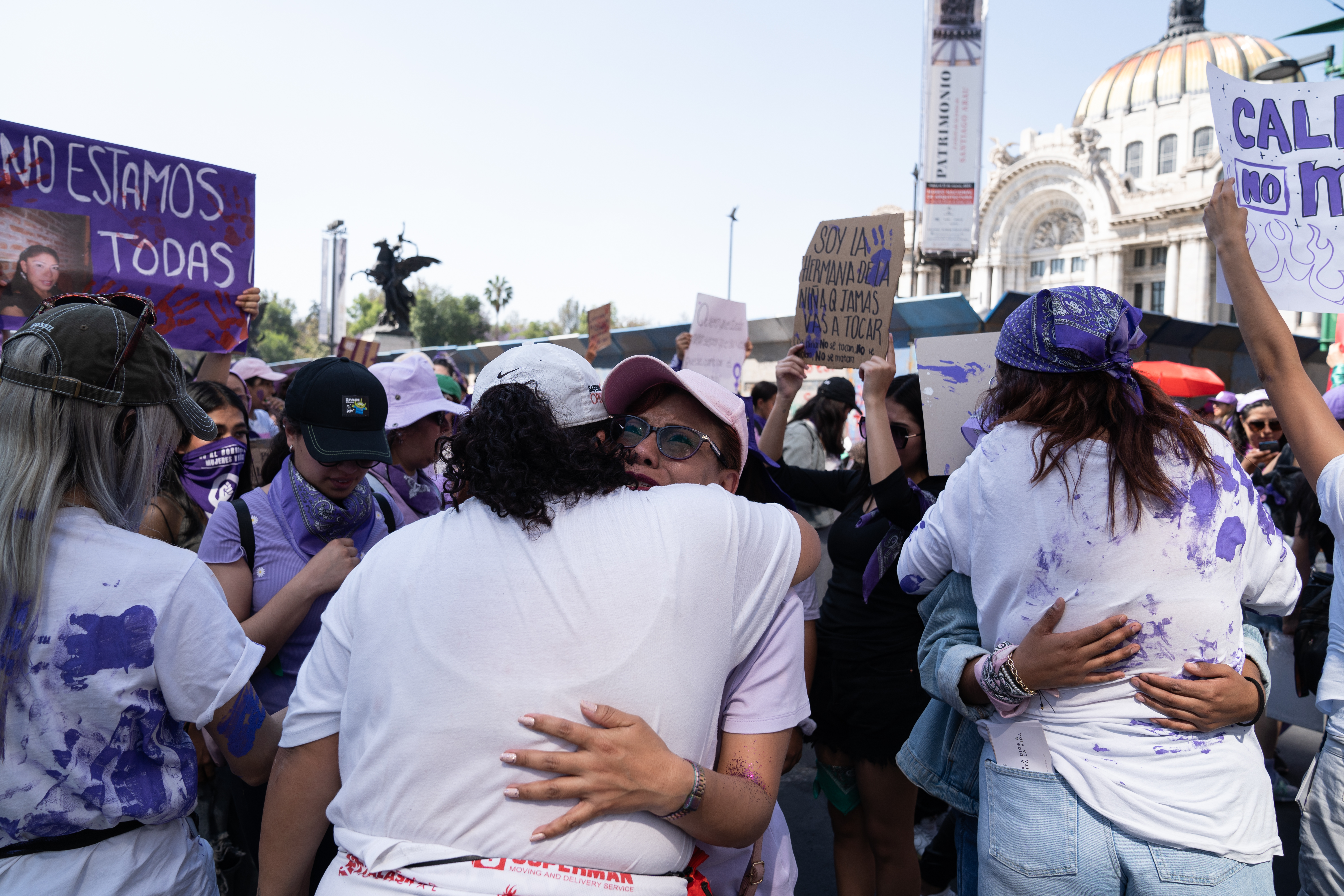 Women invite survivors of abuse to apply paint to their T-shirts. Most of the survivors cried as they painted or hugged the painted women [Lexie Harrison-Cripps / Al Jazeera]