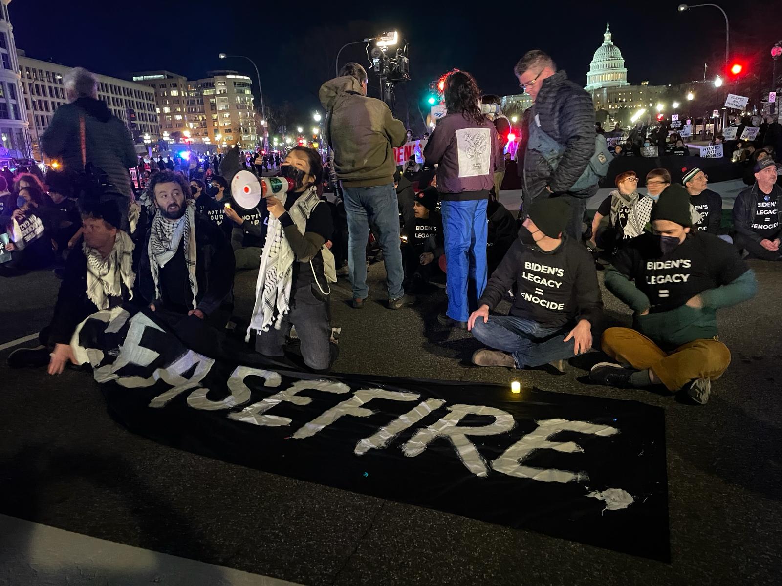 Protester with sign that says ceasefire
