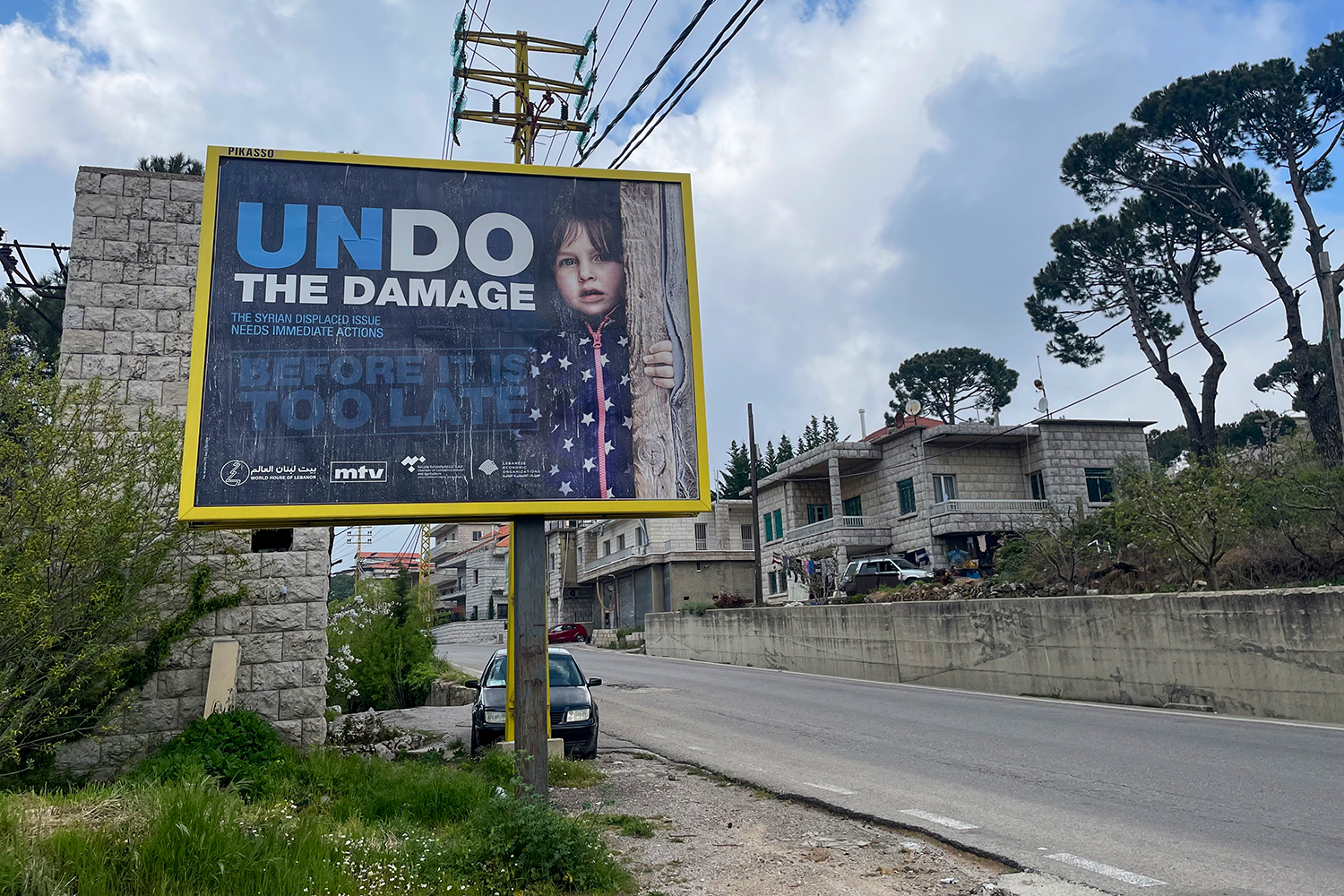 A billboard carries advertising against the Syrian refugee presence in Lebanon in the village of Mrouj