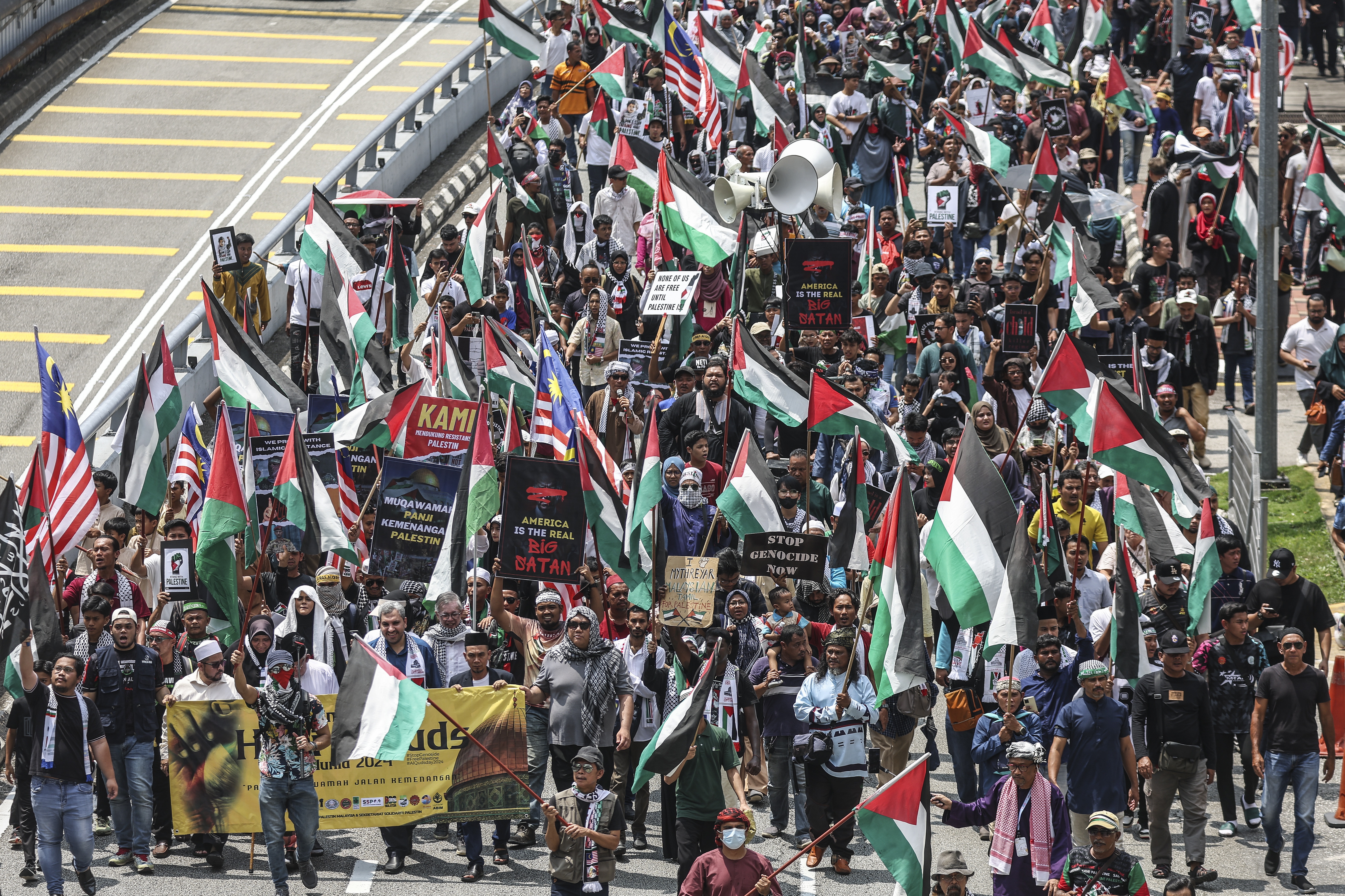 Protesters march towards the US embassy during the Al Quds Rally in solidarity with the Palestinian people, in Kuala Lumpur