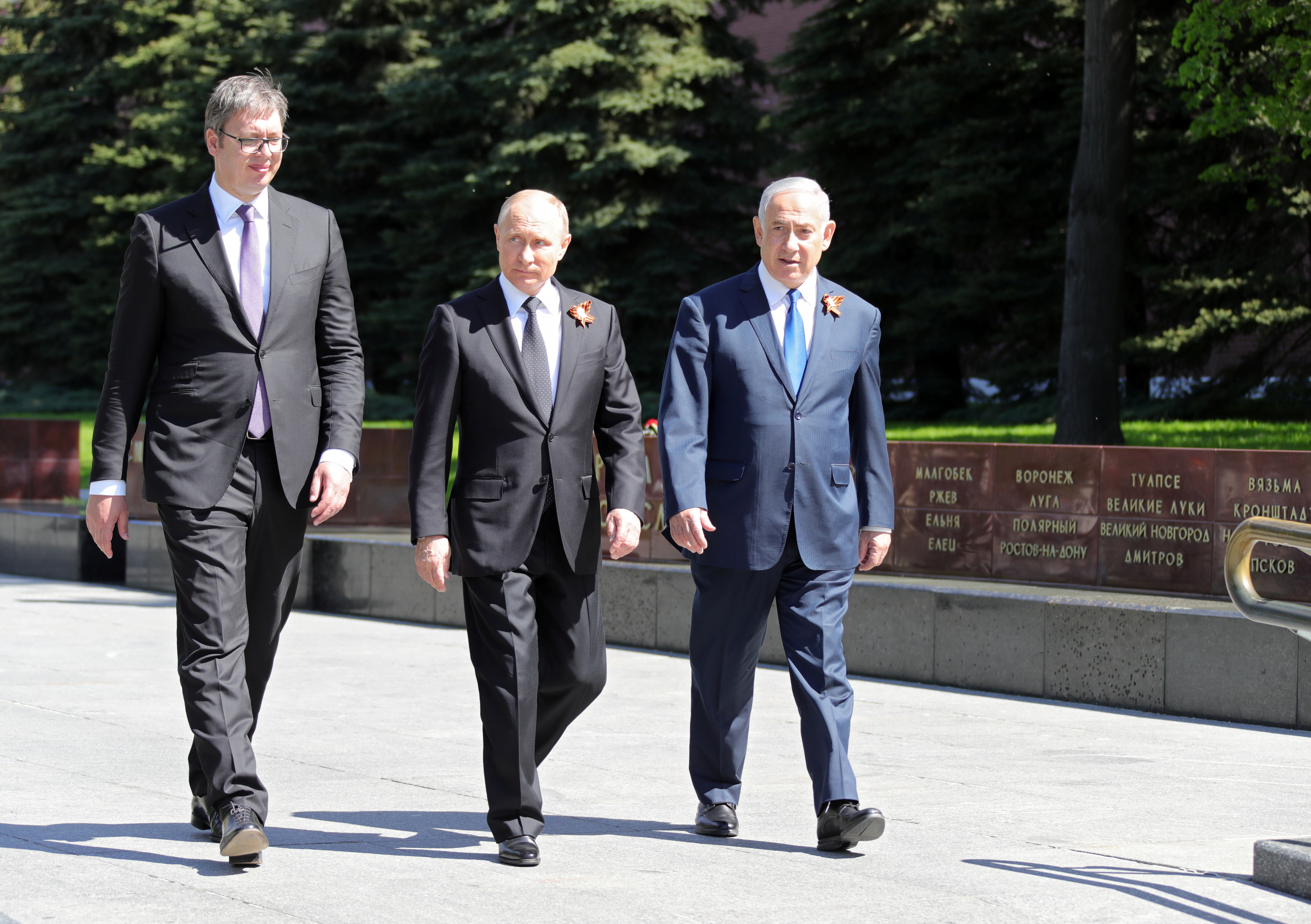 In this image from May 2018, Russian President Vladimir Putin, Prime Minister of Israel Benjamin Netanyahu, and Serbian President Aleksandar Vucic prepare to lay flowers at the Tomb of the Unknown Soldier in Alexander Garden in Moscow