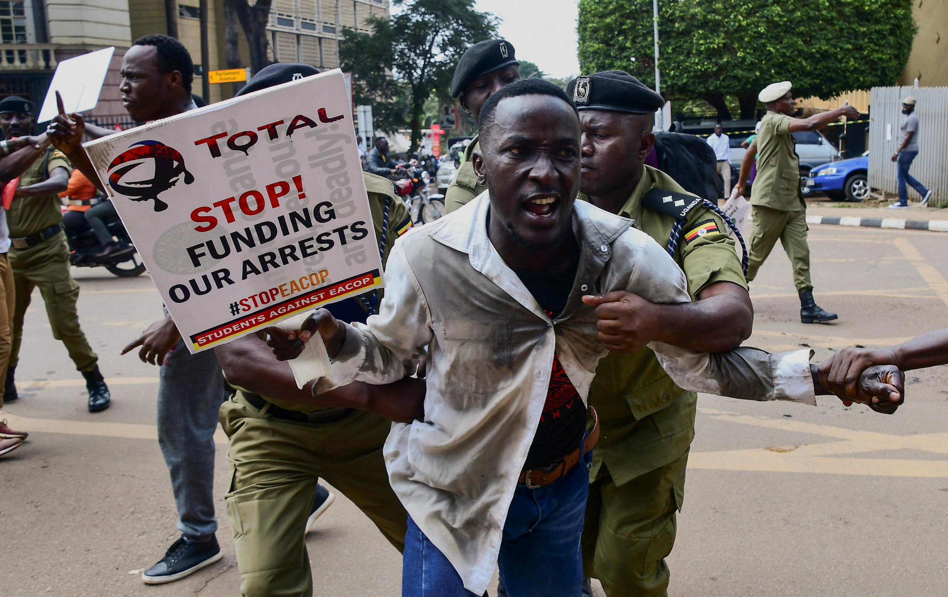 Police officers detain a Ugandan activist participating in a demonstration over proposed plans by Total Energies and the Ugandan government to build the East African Crude Oil Pipeline (EACOP), in Kampala, Uganda September 15, 2023. REUTERS/Abubaker Lubowa