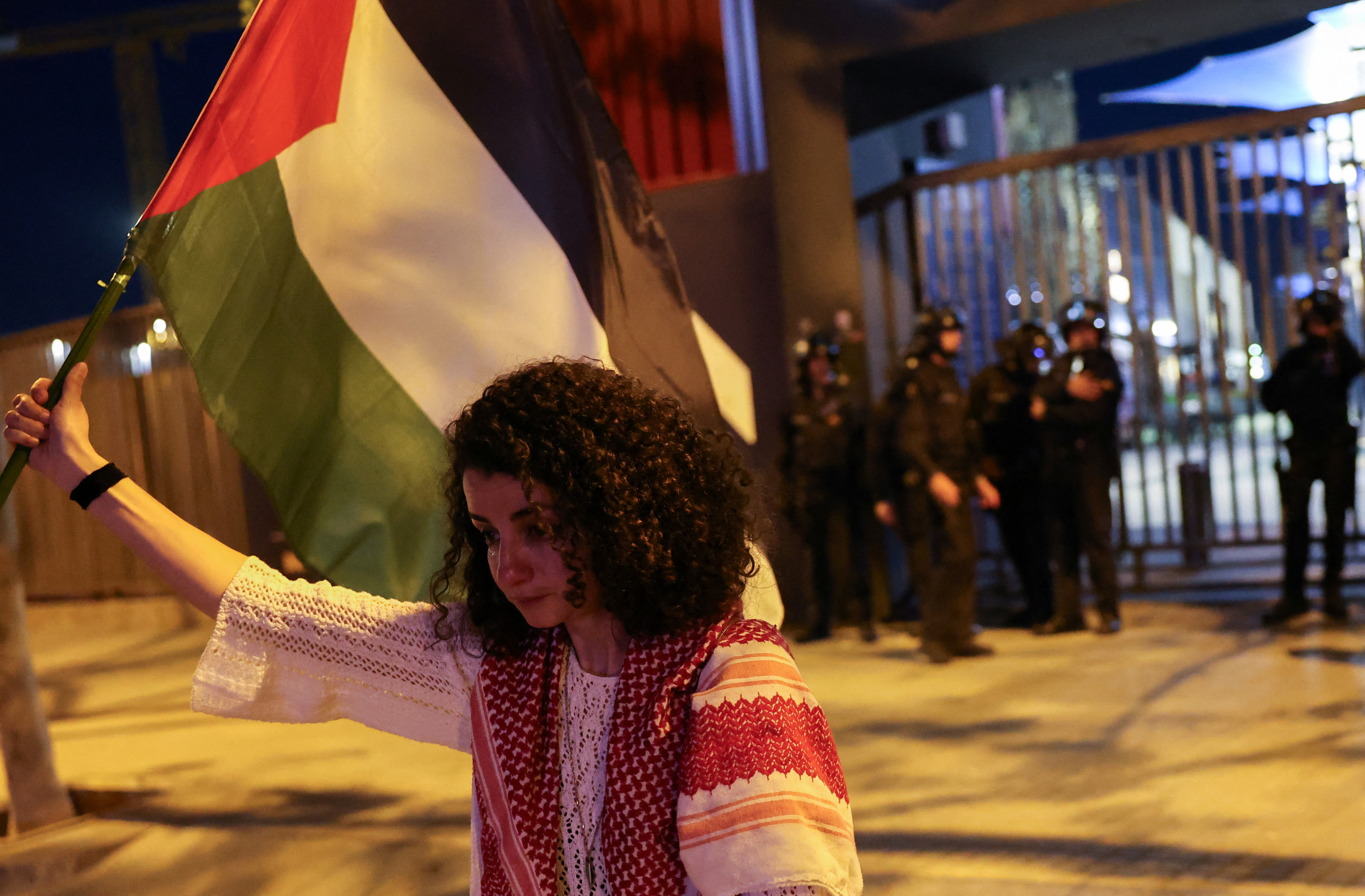 Palestinian Mervat Alramli, 31, cries as she holds her Palestinian flag in a protest at the Euroleague Basketball between Barcelona vs Maccabi Tel-Aviv Basketball outside the stadium in Barcelona, Spain, April 4, 2024. REUTERS/Nacho Doce