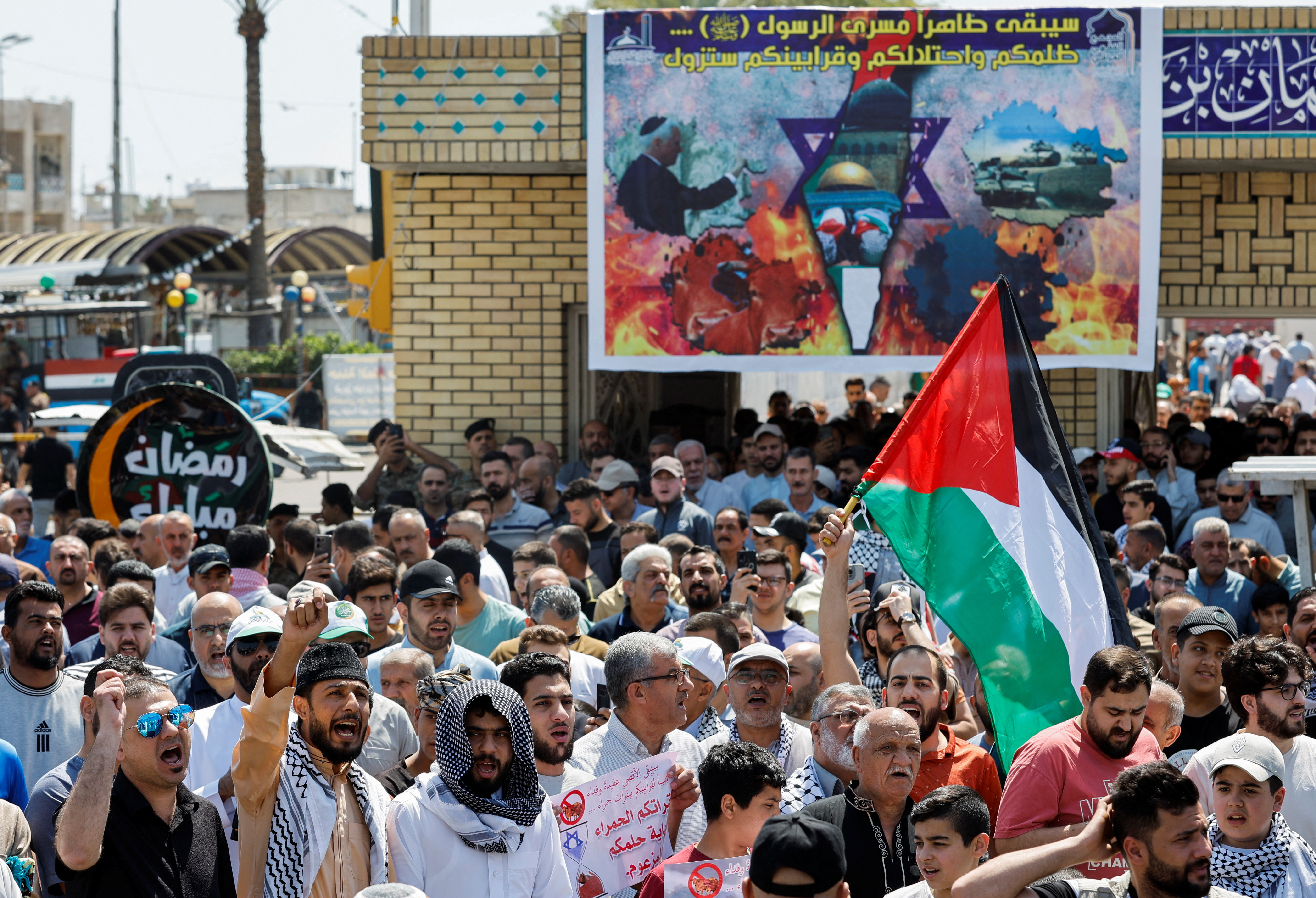 Sunni Muslims attend a rally outside Abu Hanifa mosque, marking the annual al-Quds Day (Jerusalem Day) and to show their support with Gaza