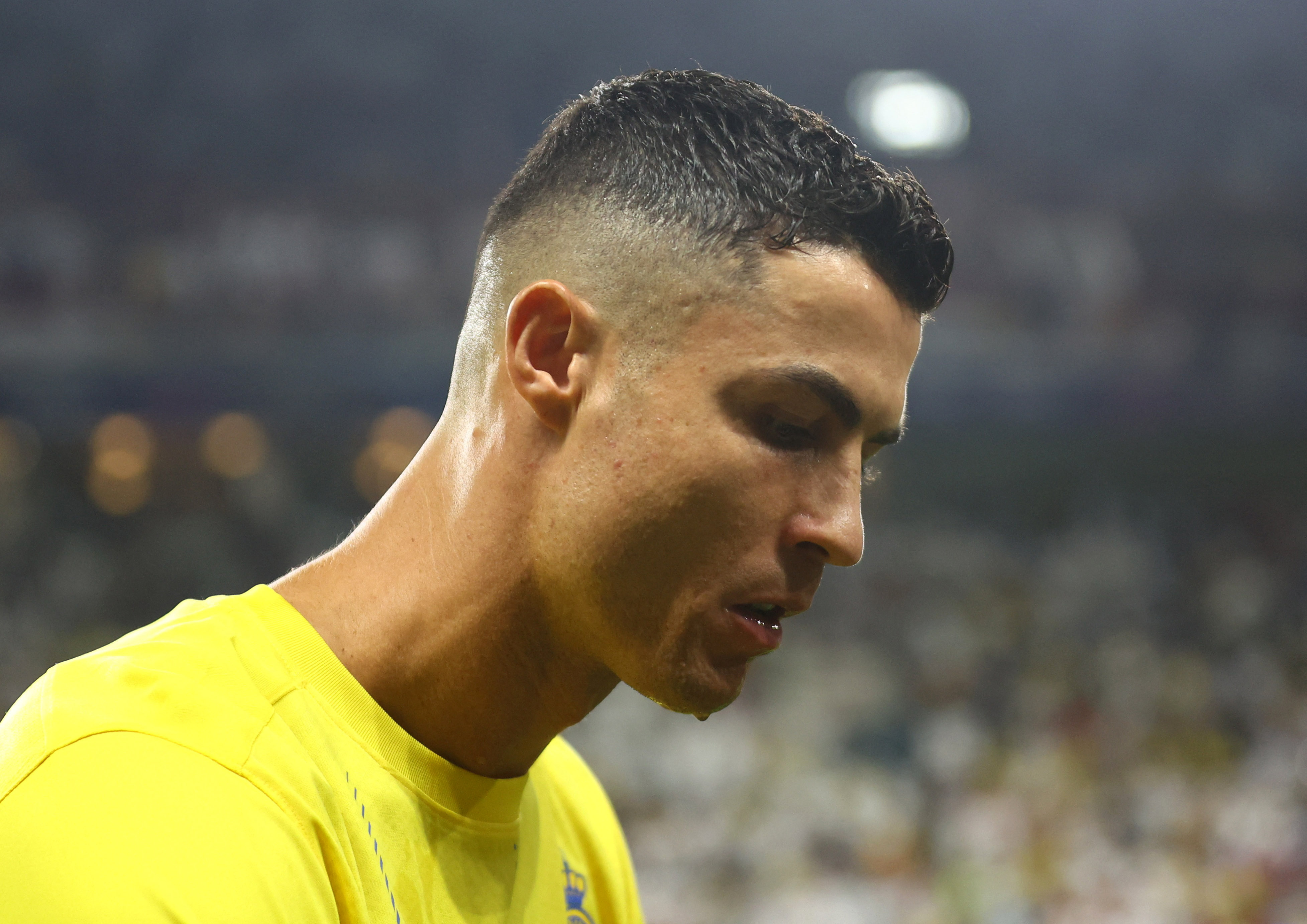 Al Nassr's Cristiano Ronaldo walks on field.