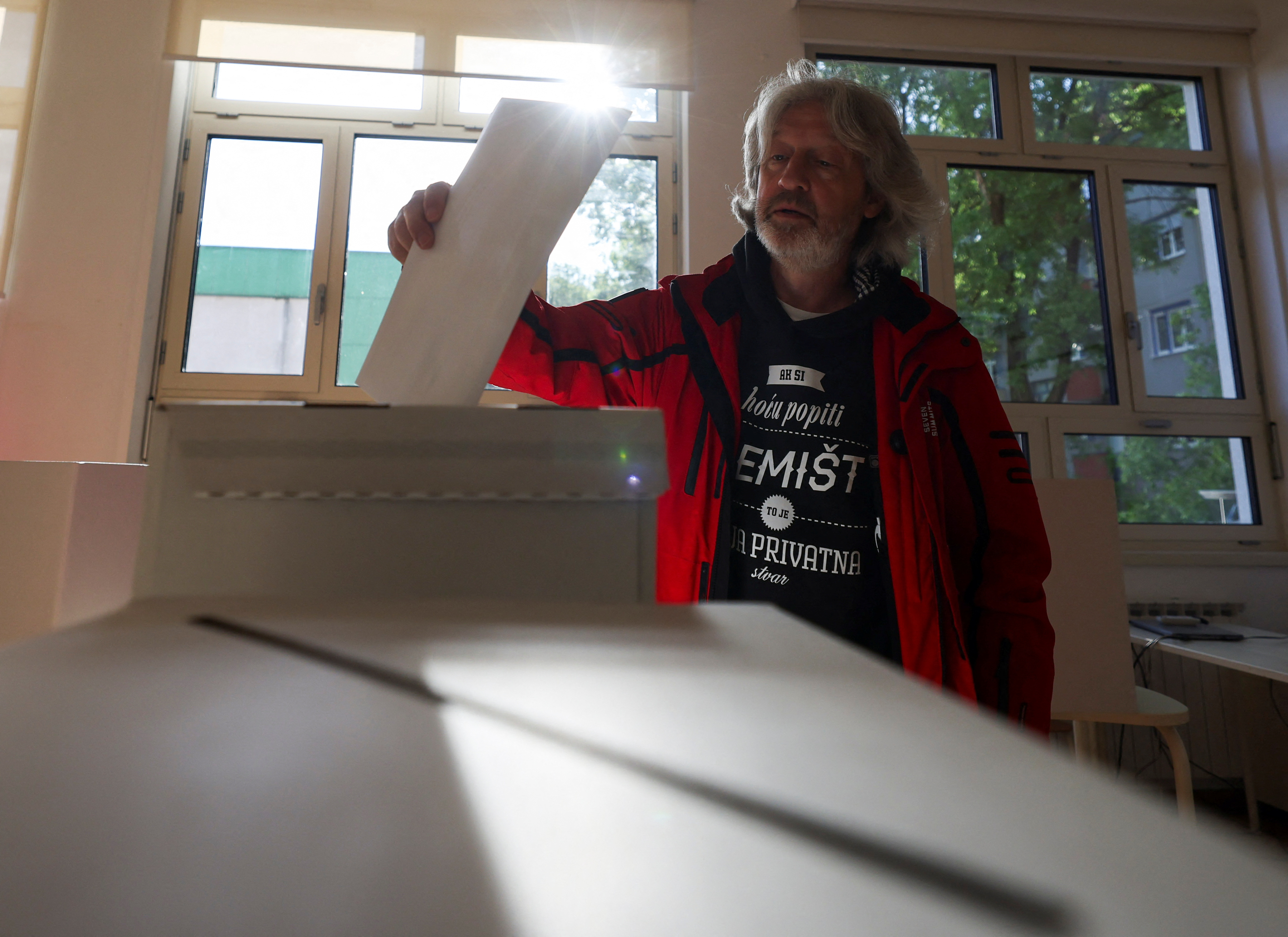 A person votes at a polling station during the parliamentary elections in Zagreb, Croatia, April 17, 2024. REUTERS/Antonio Bronic