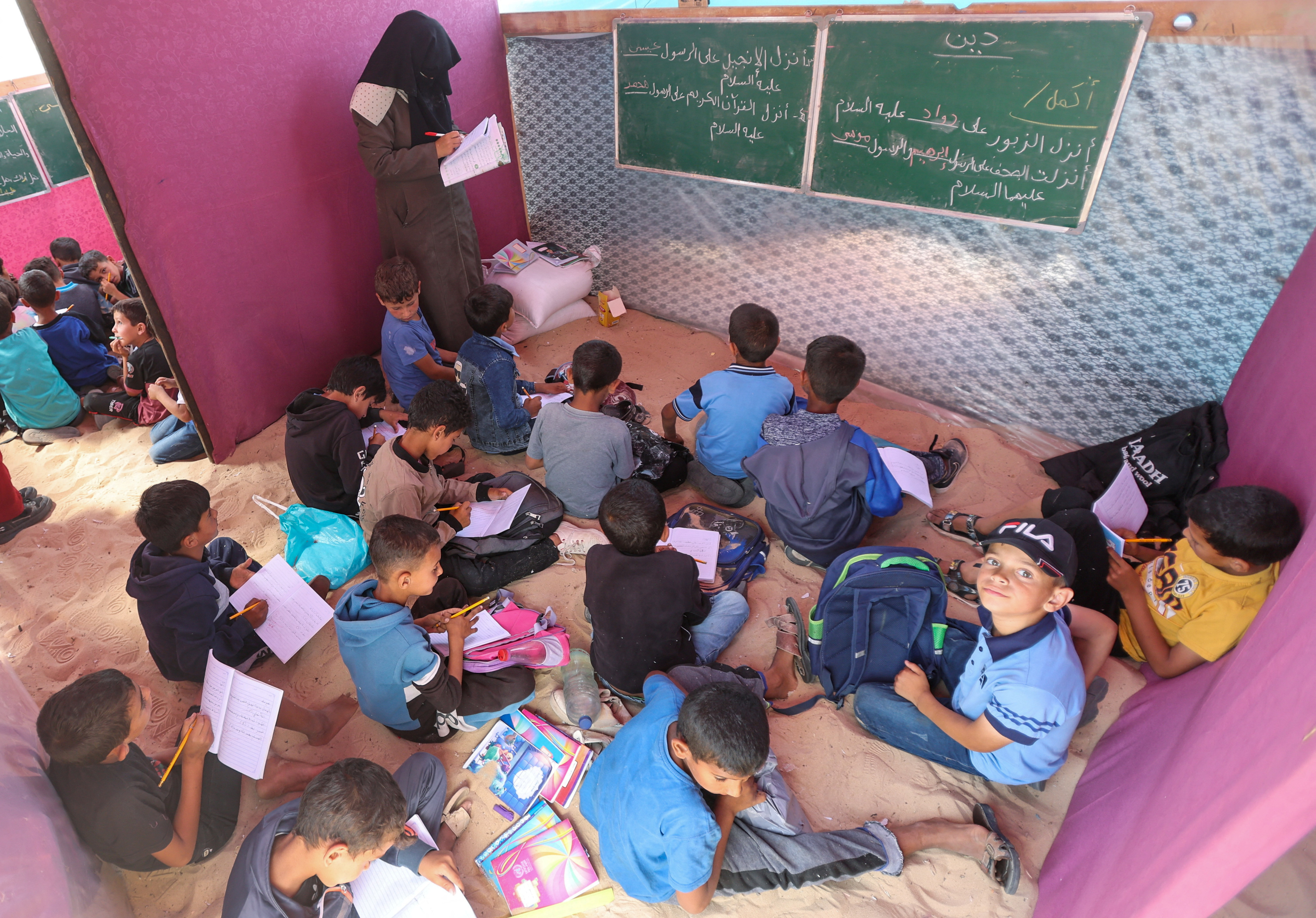Palestinian students study in a makeshift tent camp as schools remain closed due to Israel's military offensive, amid the ongoing conflict between Israel and the Palestinian Islamist group Hamas, in Khan Younis, southern Gaza Strip, April 28, 2024. REUTERS/Ramadan Abed