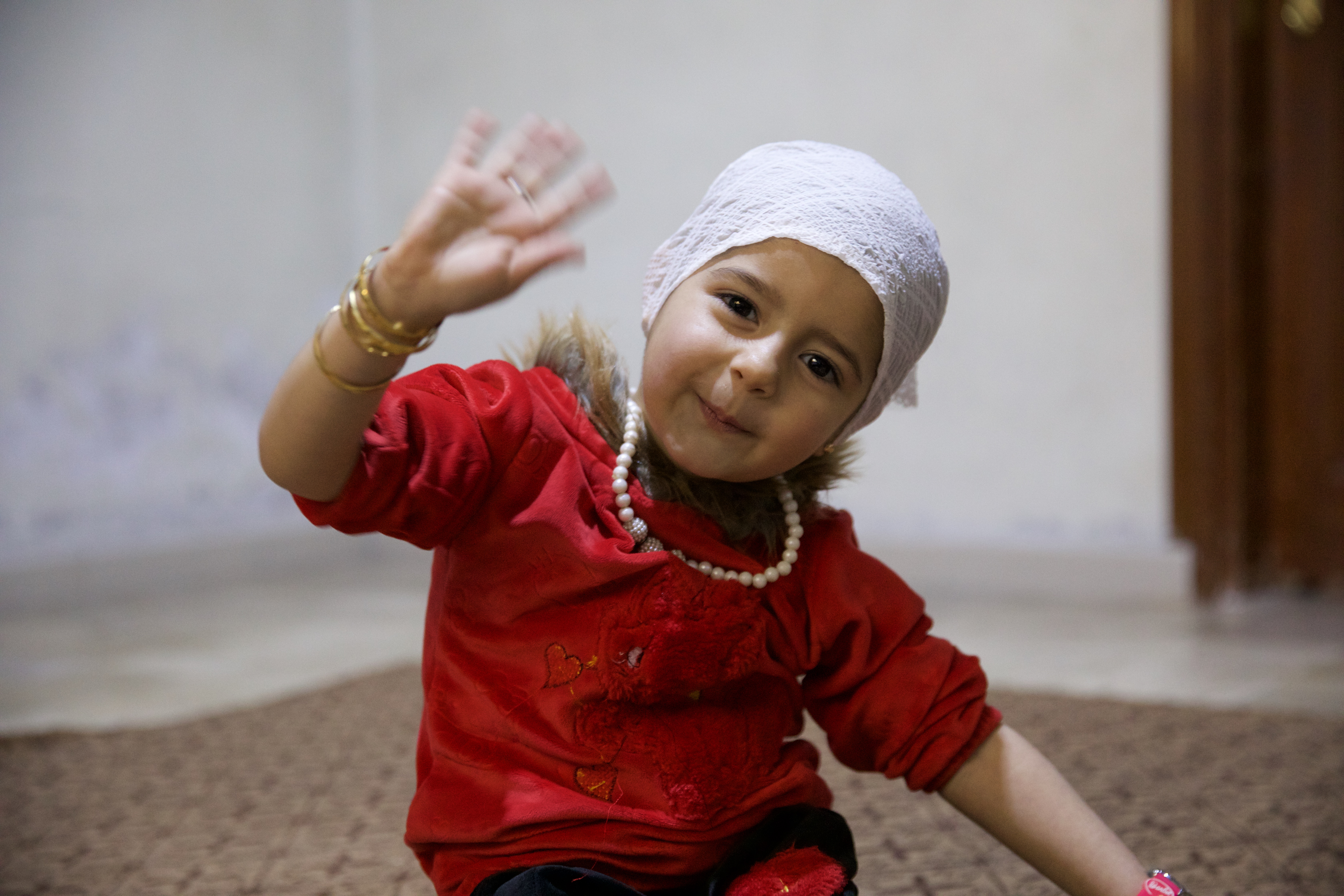 Celine smiles and waves