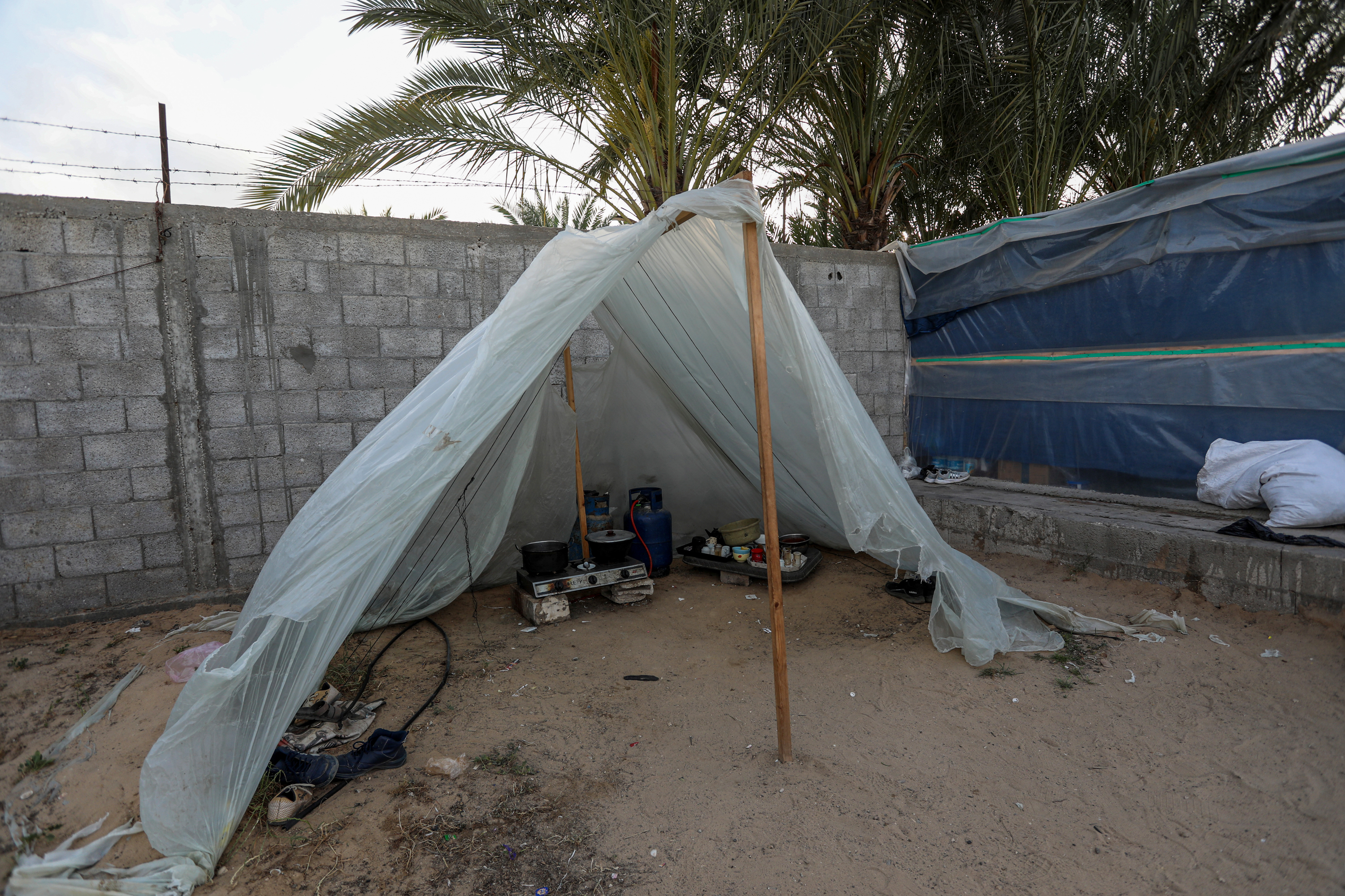 The makeshift kitchen is plastic sheeting on two sticks