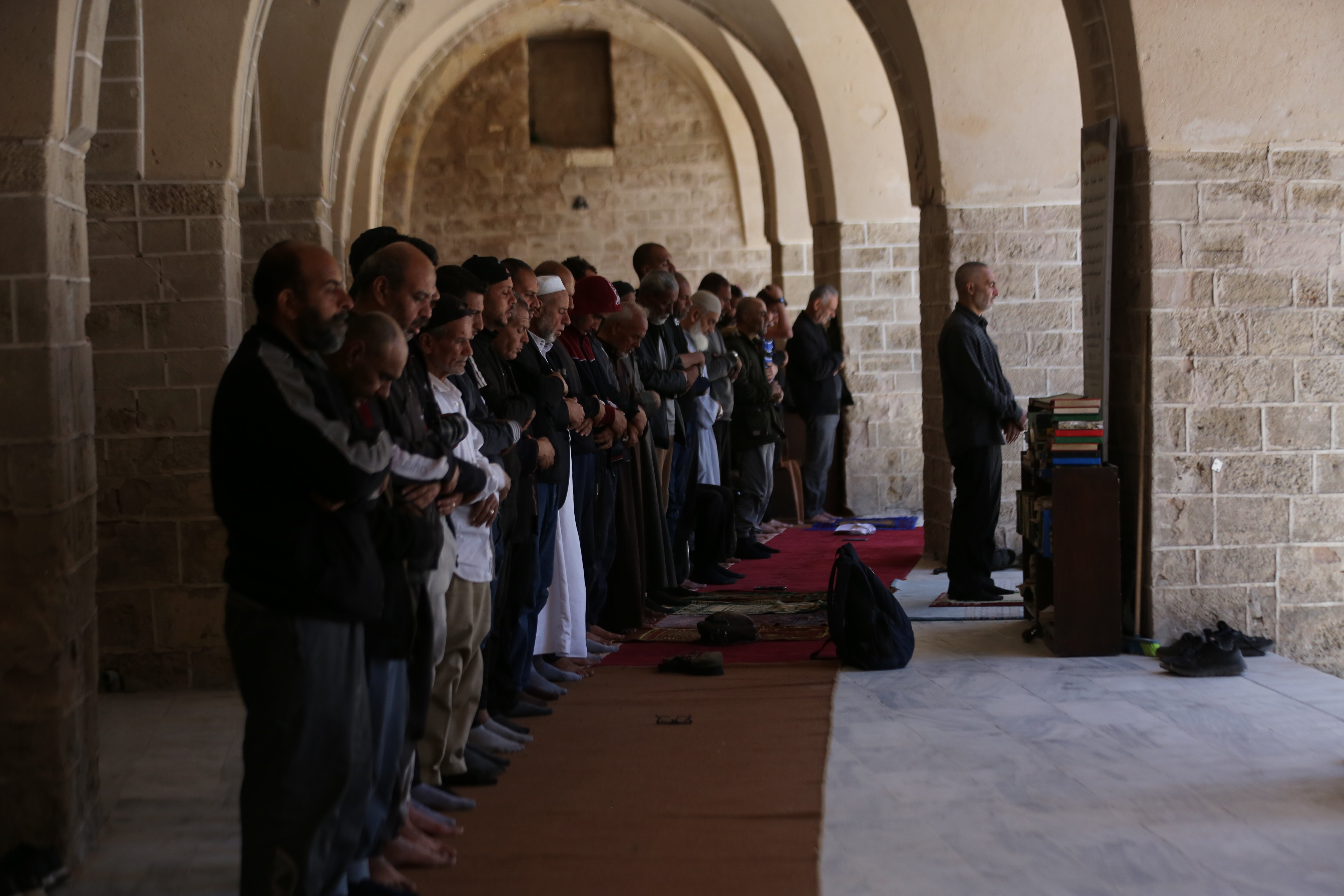 Palestinians gather to read the Holy Qur'an during the last days of Ramadan, in the remaining part of the historic "Great Omari Mosque," also known as the "Great Mosque of Gaza," following its destruction by Israeli military bombardments in Gaza on April 06