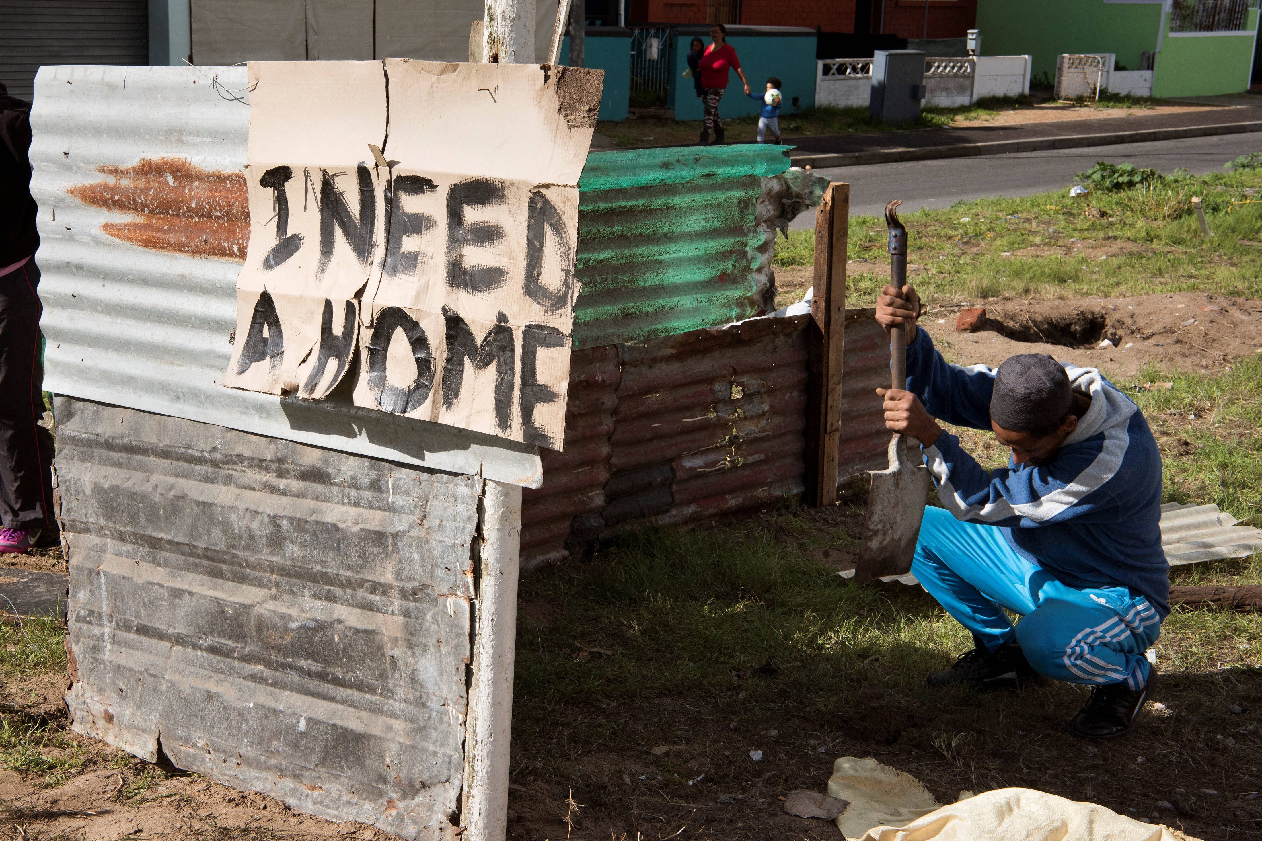 A man builds a shack in South Africa