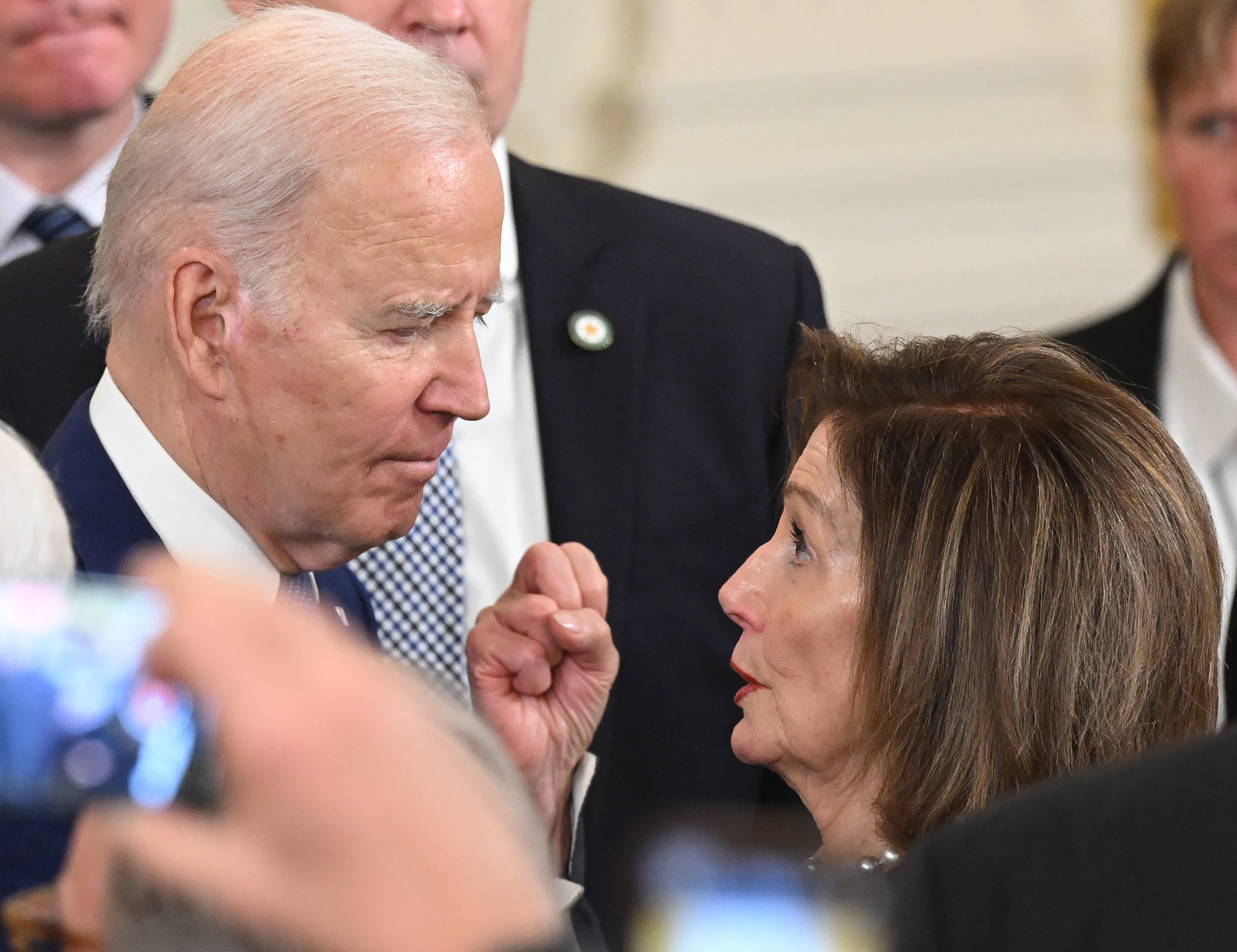US President Joe Biden talks with US Representative Nancy Pelosi, Democrat of California, after speaking at a ceremony marking the 13th anniversary of the Affordable Care Act in the East Room of the White House in Washington, DC, March 23, 2023. (Photo by SAUL LOEB / AFP)