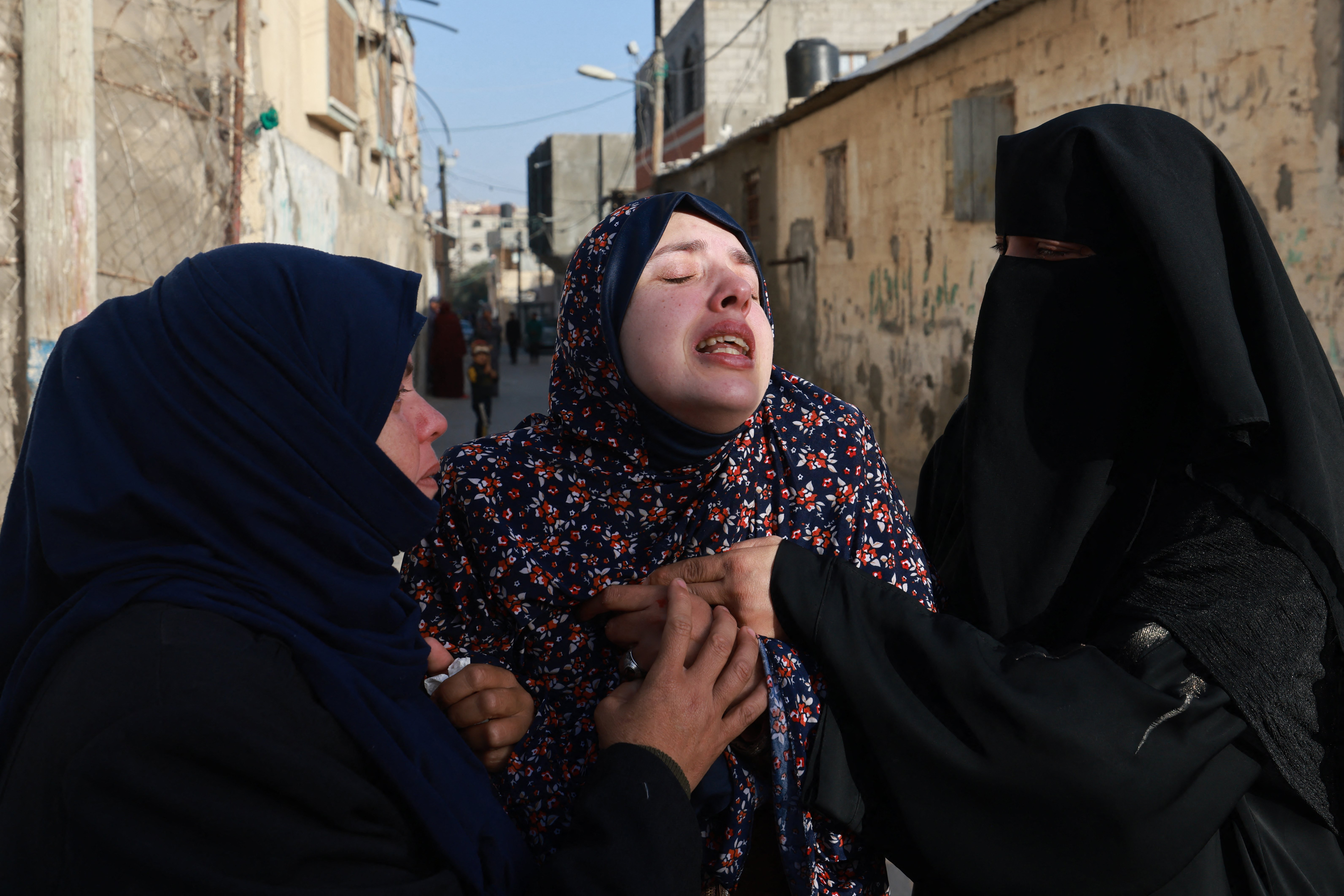 Rania Abu Anza (C) the mother of twin babies Naeem and Wissam, killed in an overnight Israeli air strike, mourns their death ahead of their burial in Rafah in the southern Gaza Strip on March 3, 2024, as the conflict between Israel and the Palestinian militant group Hamas continues.