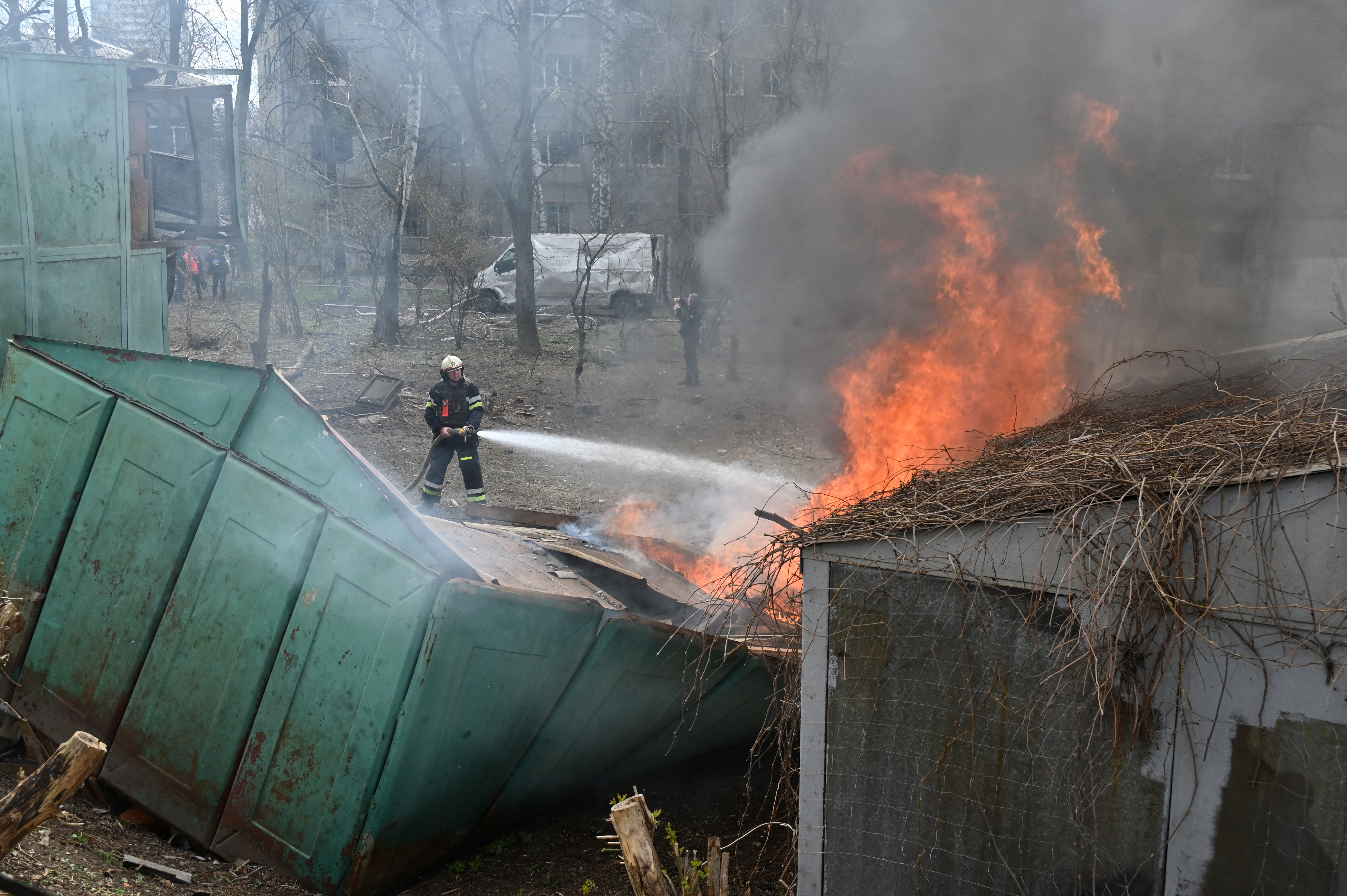 Firefighters putting out the flames at the site of a Russian missile attack in Kharkiv.