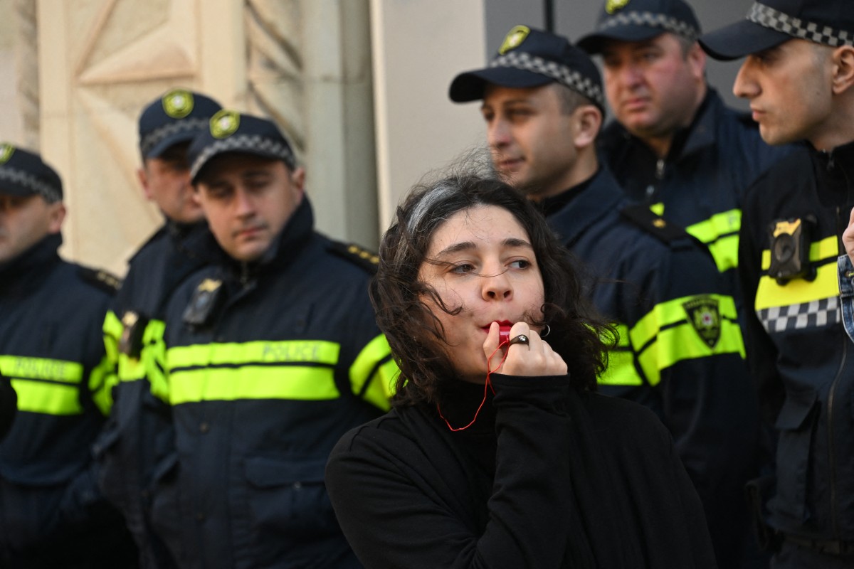 Georgian pro-democracy groups activists protest against a repressive "foreign influence" bill outside the parliament