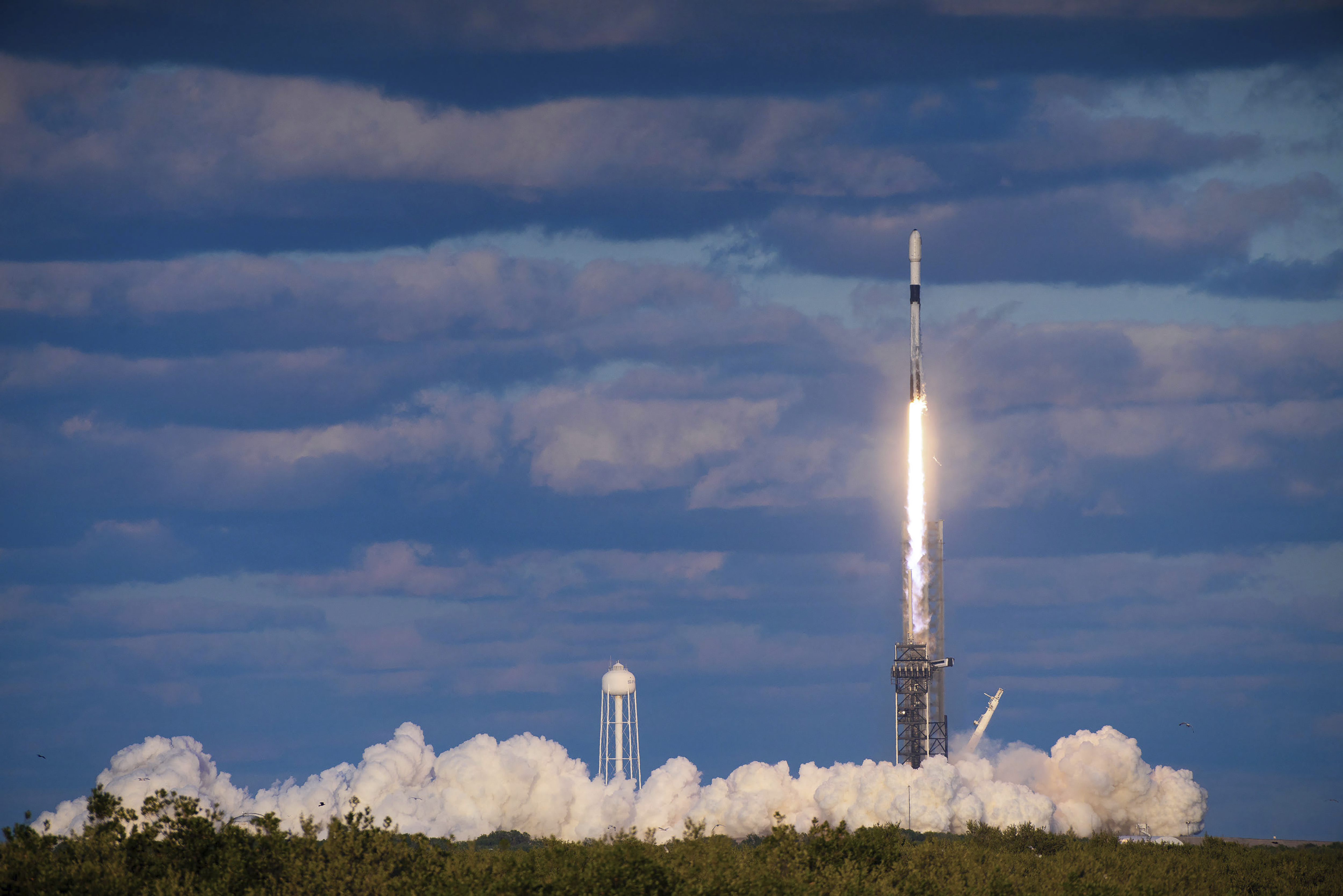 The spy satellite taking off on a SpaceX rocket from Kennedy Space Center in Florida. There's lots of smoke left behind.