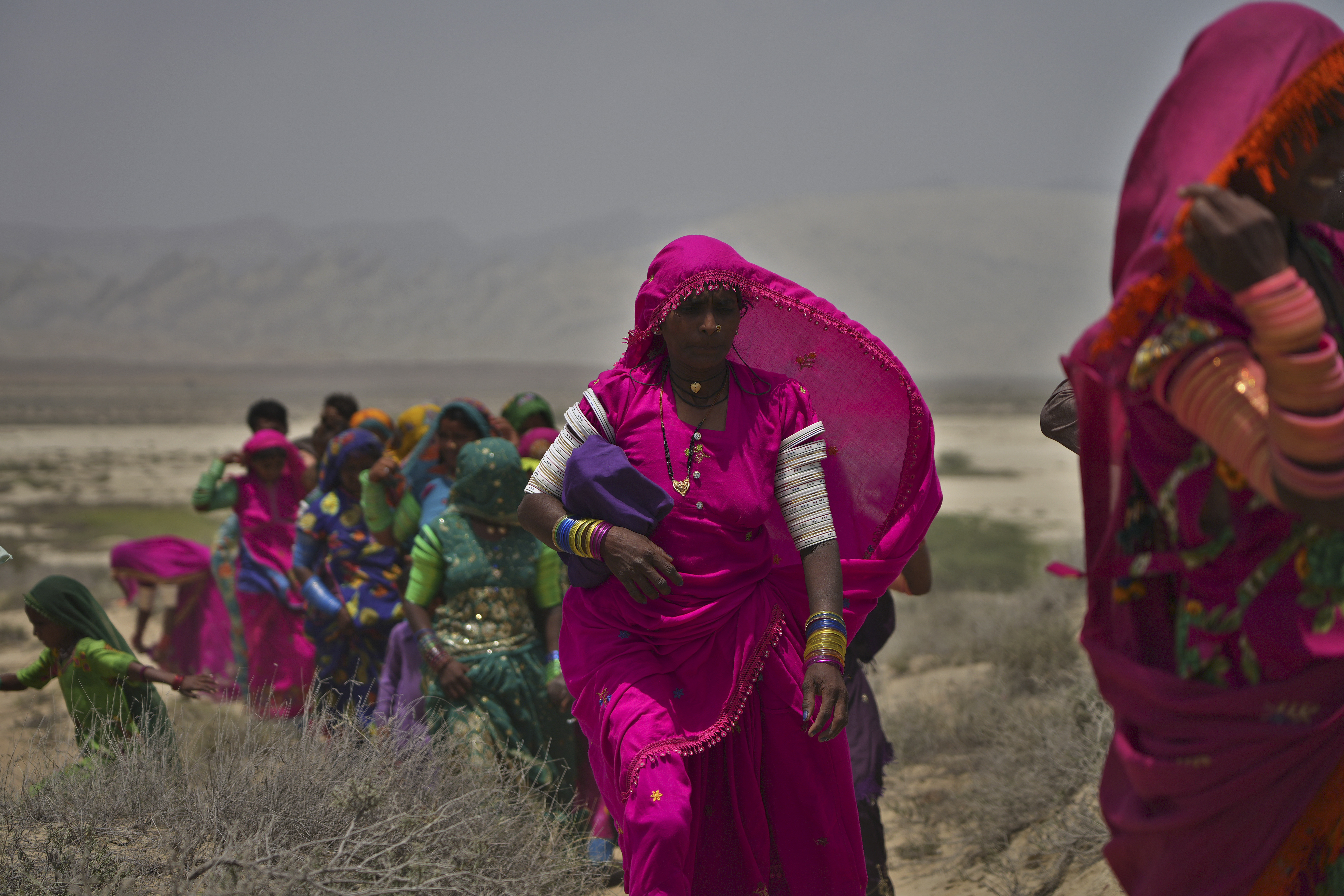 Hindu devotees walk toward a mud volcano to start Hindu pilgrims' religious rituals for an annual festival in an ancient cave temple of Hinglaj Mata in Hinglaj in Lasbela district in the Pakistan's southwestern Baluchistan province, Friday, April 26