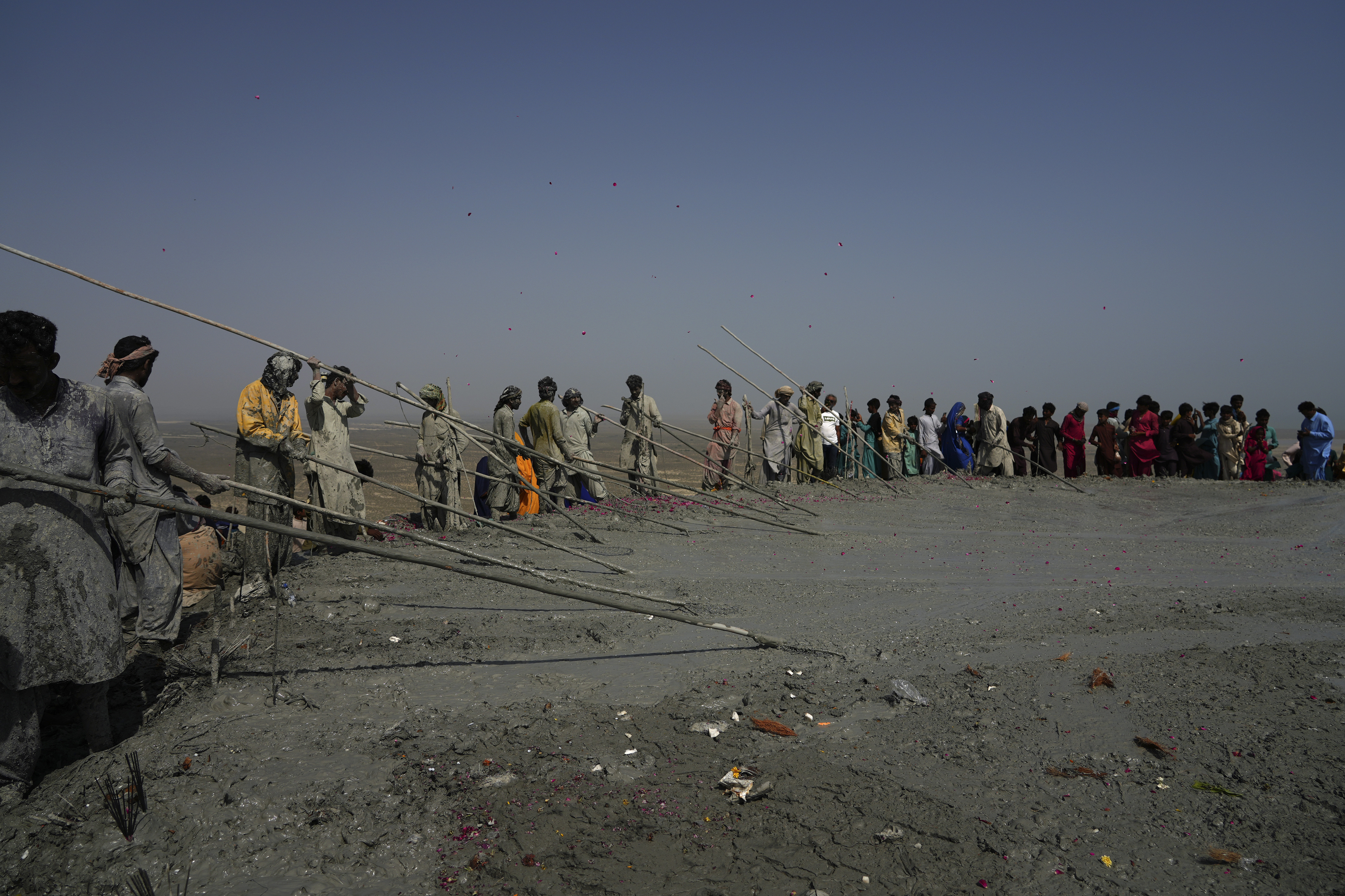 Hindu devotees perform their rituals on a mud volcano to start Hindu pilgrims' religious rituals for an annual festival in an ancient cave temple of Hinglaj Mata in Hinglaj in Lasbela district in the Pakistan's southwestern Baluchistan province