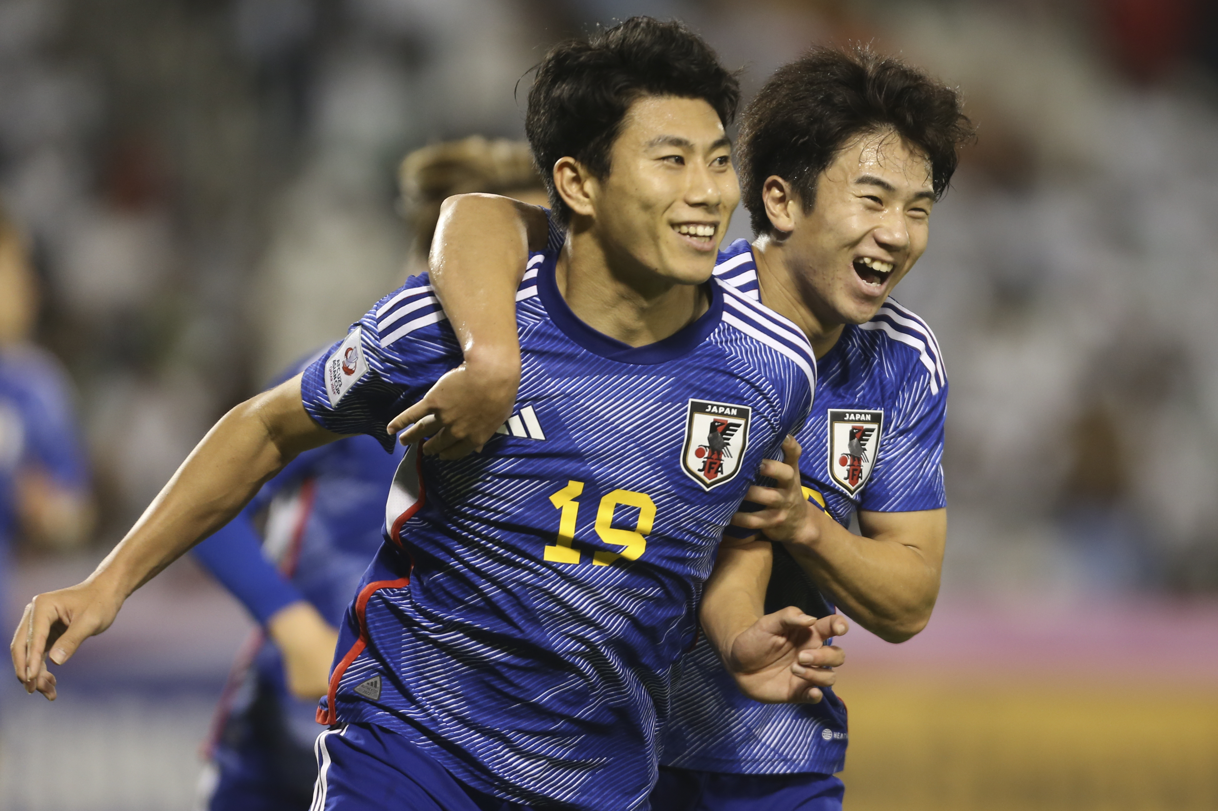 Japan's Mao Hosoya, left, celebrates after scoring during an Under 23 Asian Cup semifinal against Iraq [Hussein Sayed/AP]