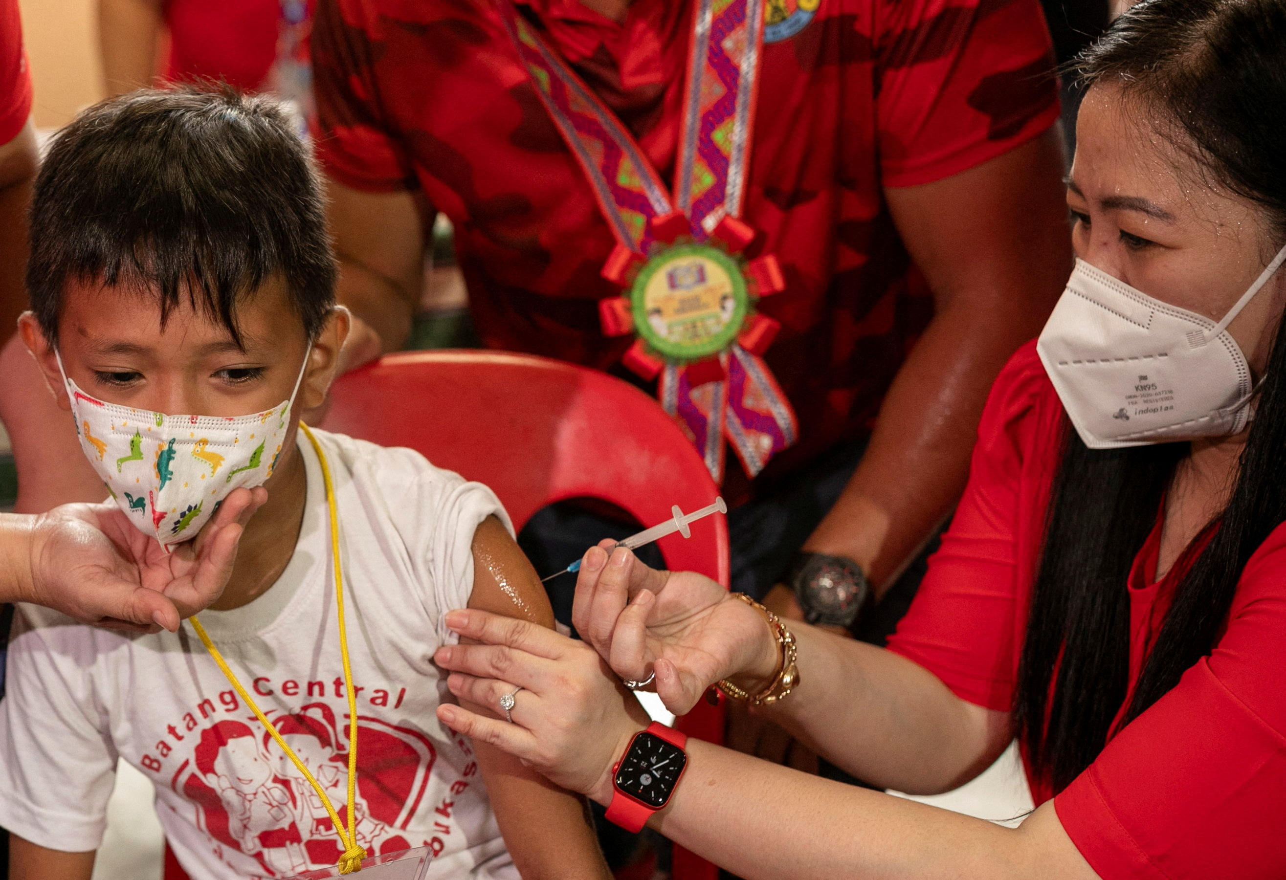 A student receives a dose of the Pfizer coronavirus disease (COVID-19) vaccine on the first day of in-person classes at a public school in San Juan City, Philippines, August 22, 2022. REUTERS/Eloisa Lope