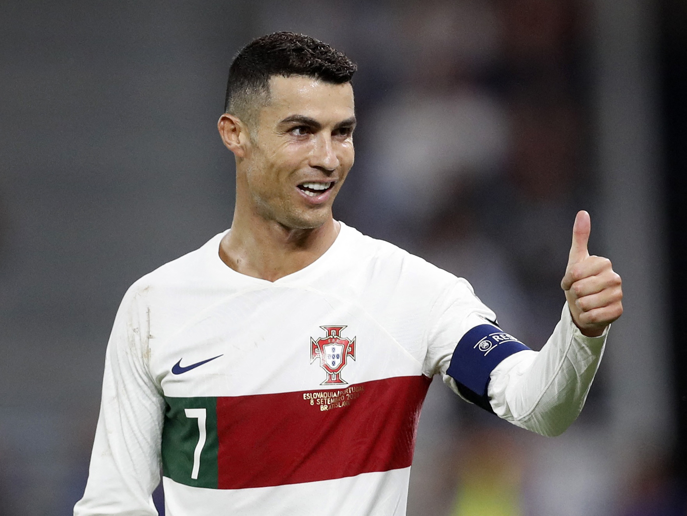 Ronaldo makes a thumbs up gesture during a football match