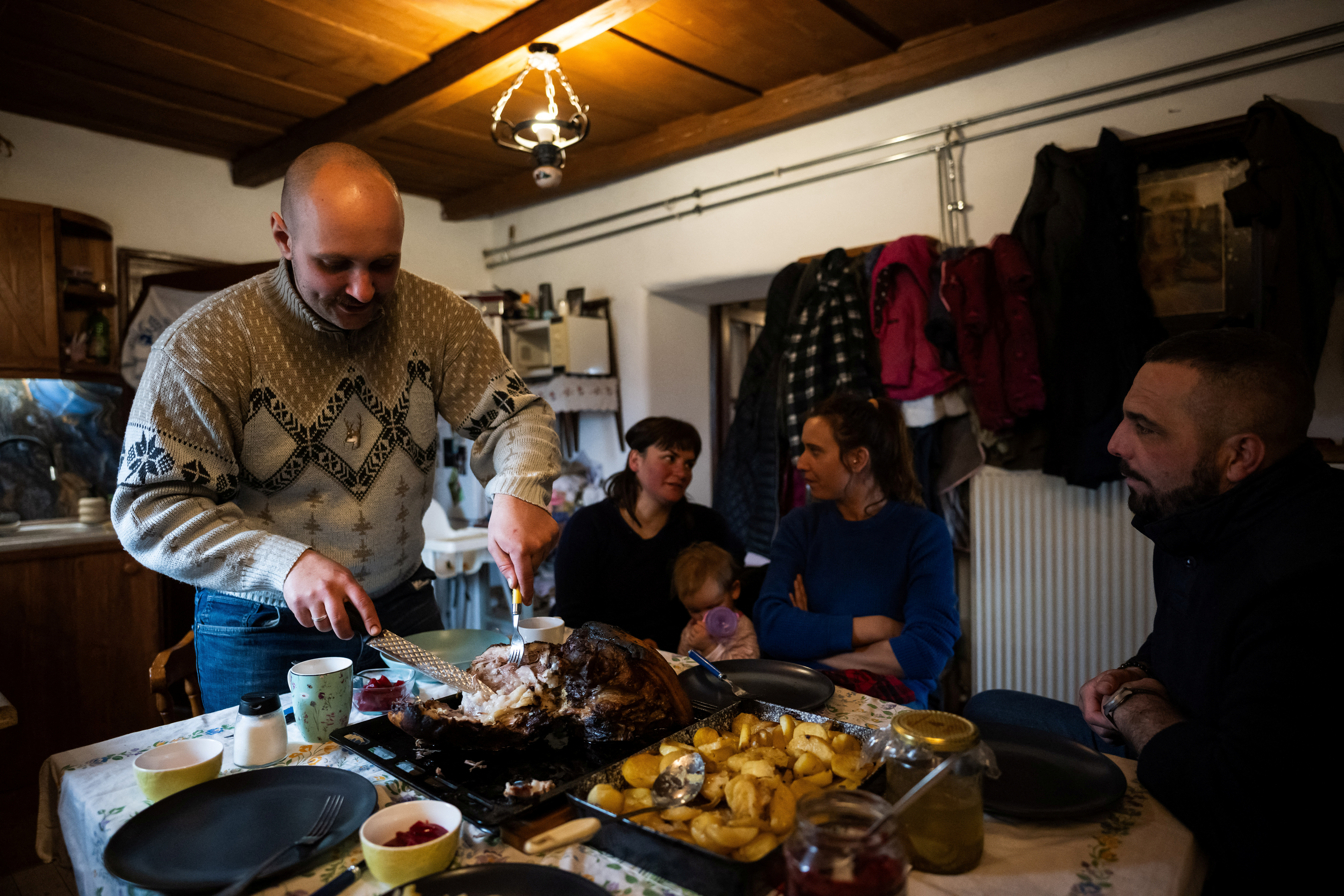 Laszlo Kemencei, 28, with his wife Cintia Mnyere, 31, their daughter Baroka, and their friends Krisztian Kisjuhasz, 41, and his partner Zsanett Homoki, 34, have lunch at Kemencei's farm near Ladanybene, Hungary