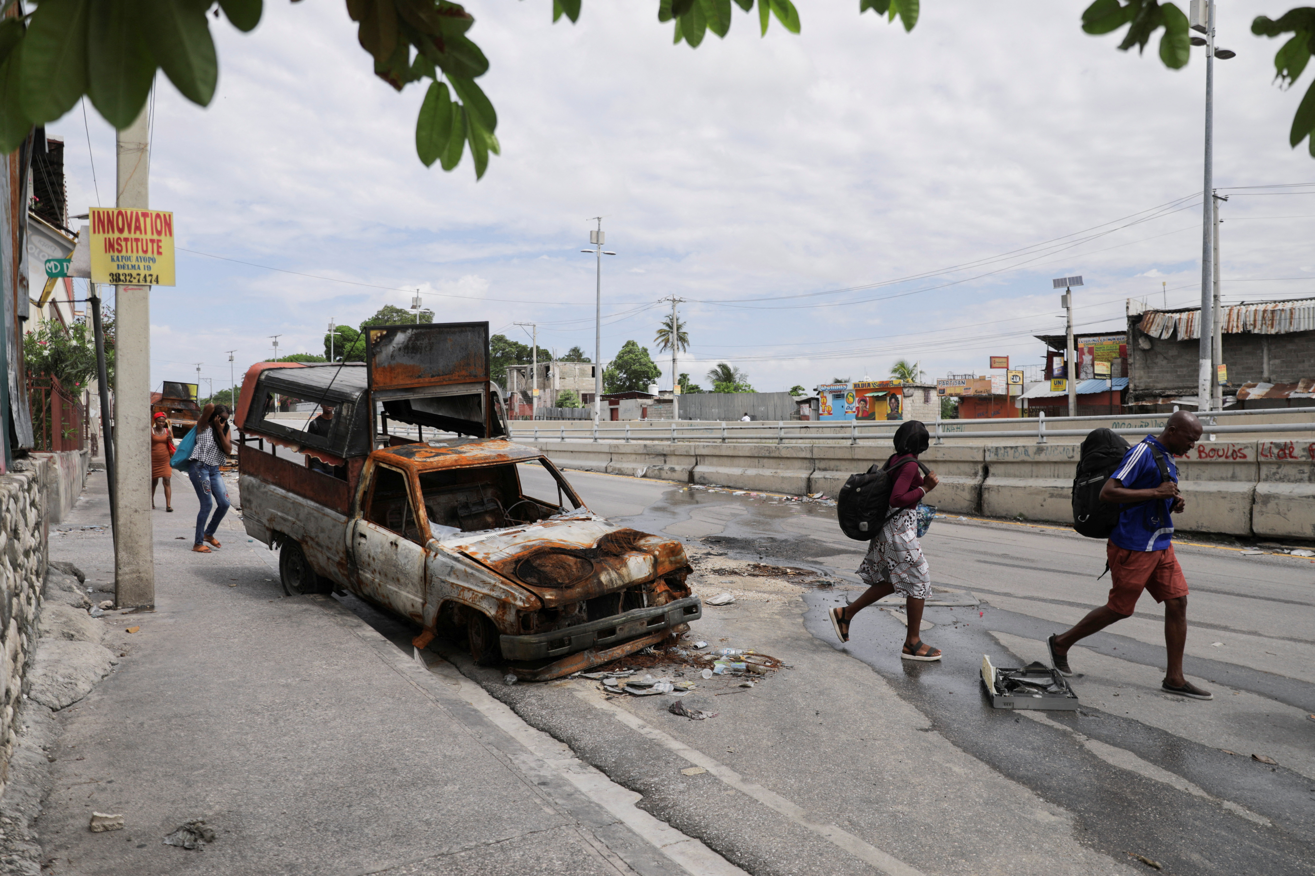 Residents carry their belongings as they flee their homes due to gang violence in Port-au-Prince, Haiti