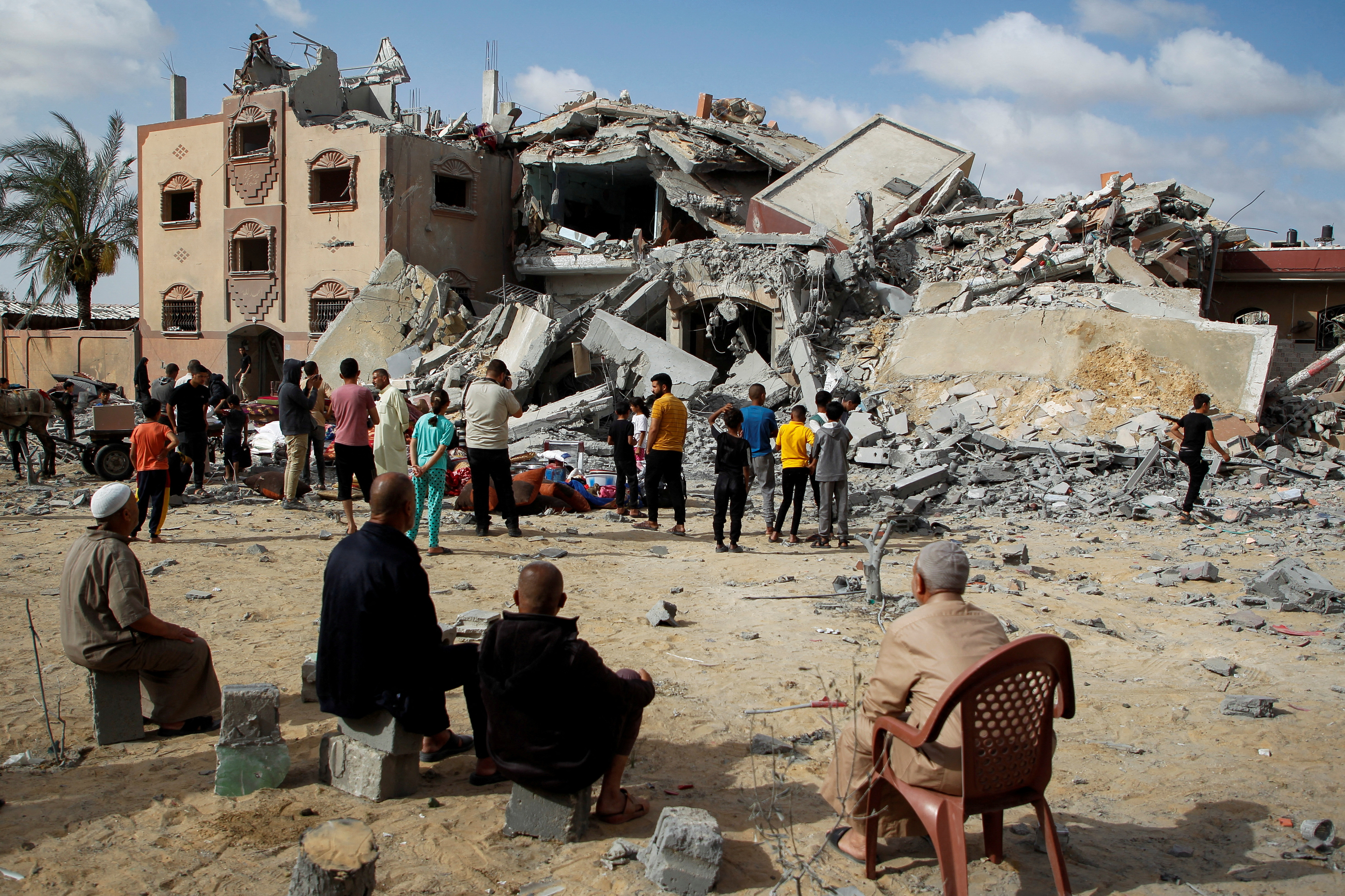 Palestinians look at the site of an Israeli strike on a house, amid the ongoing conflict between Israel and Hamas, in Rafah, in the southern Gaza Strip May 5