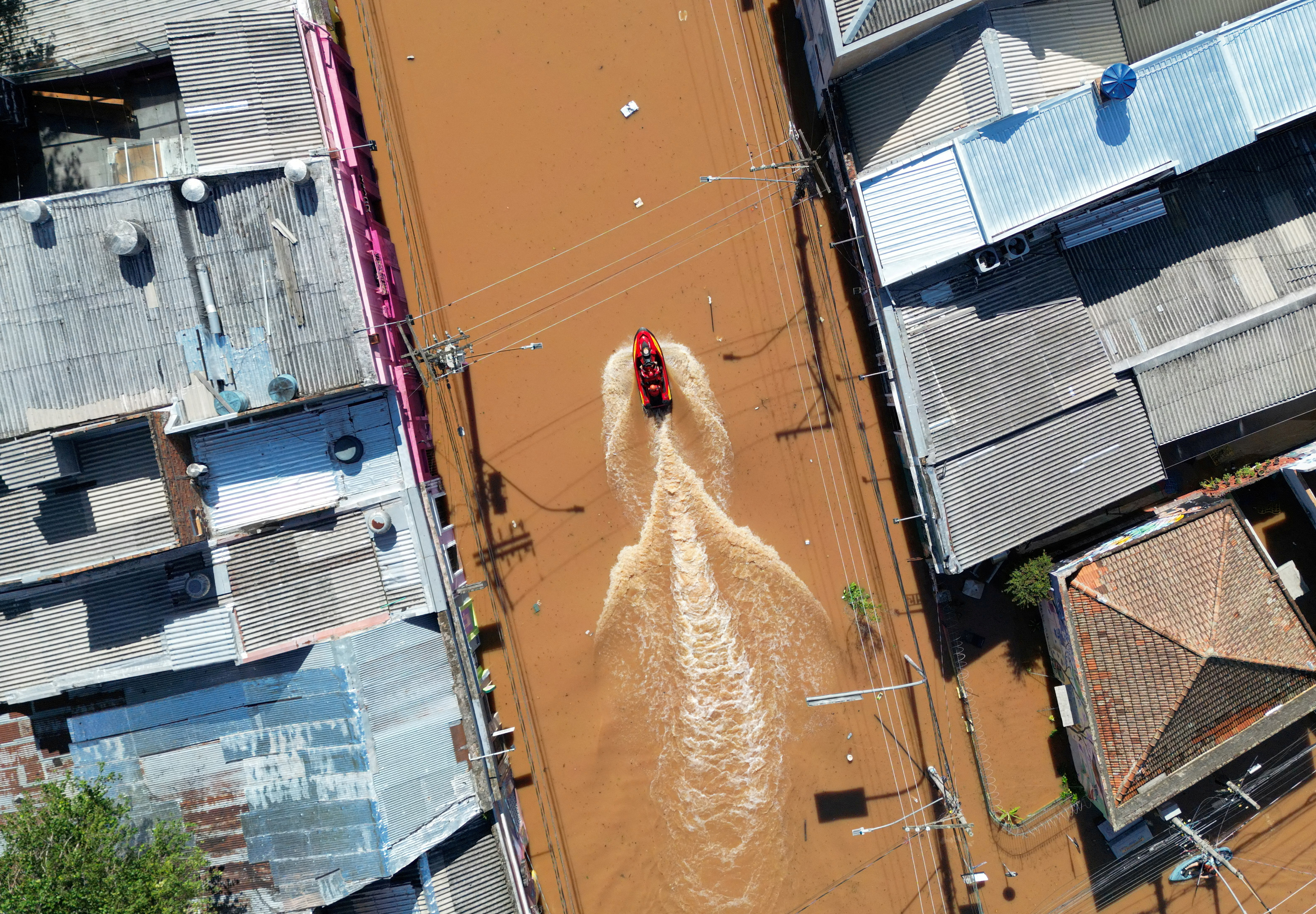 A view of rescuers driving a boat in flood waters in Brazil