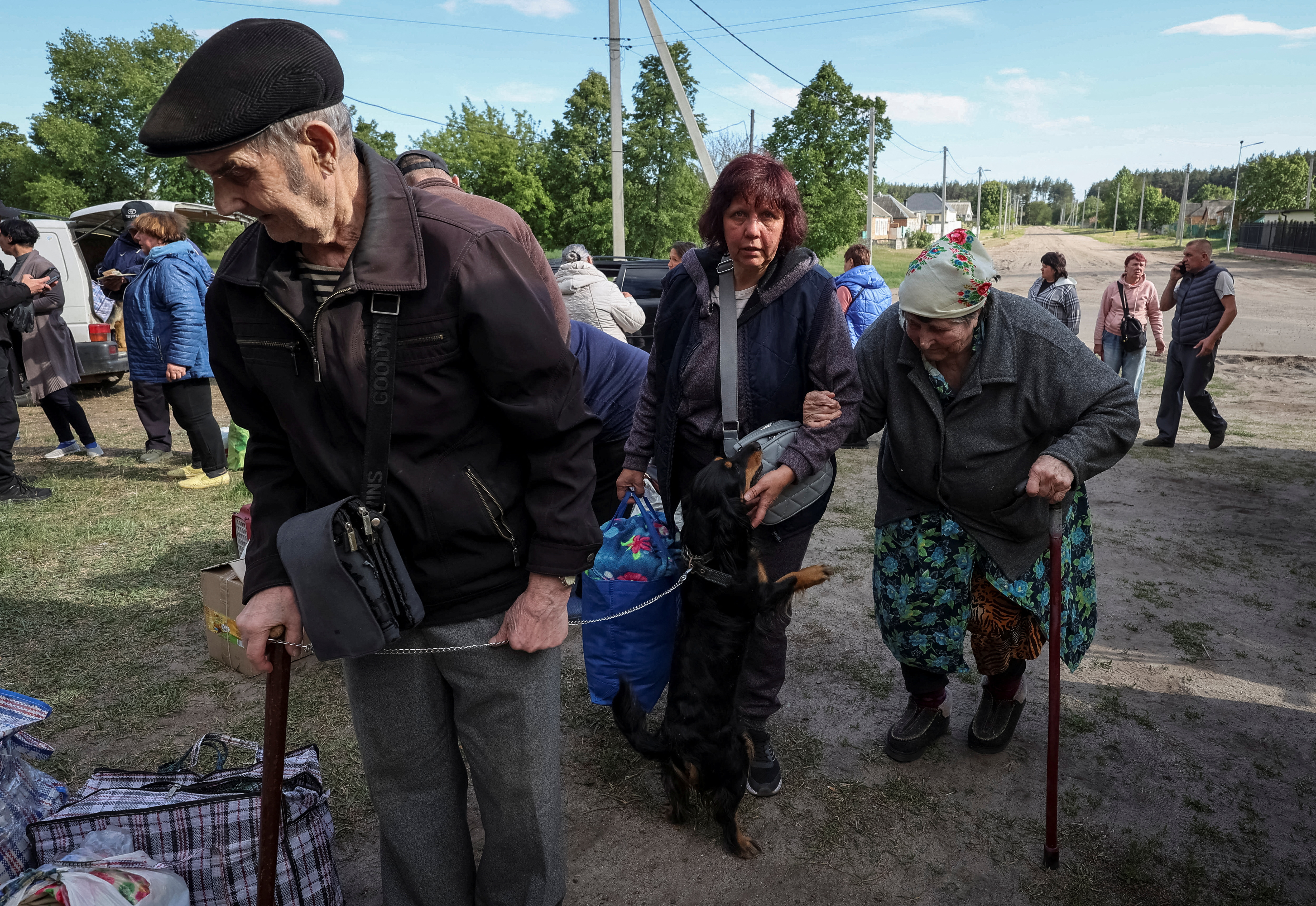 Residents from Vovchansk and nearby villages wait for buses amid an evacuation to Kharkiv due to Russian shelling, amid Russia's attack on Ukraine, at an undisclosed location near the town of Vovchansk in Kharkiv region, Ukraine May 10, 2024. REUTERS/Vyacheslav Madiyevskyy