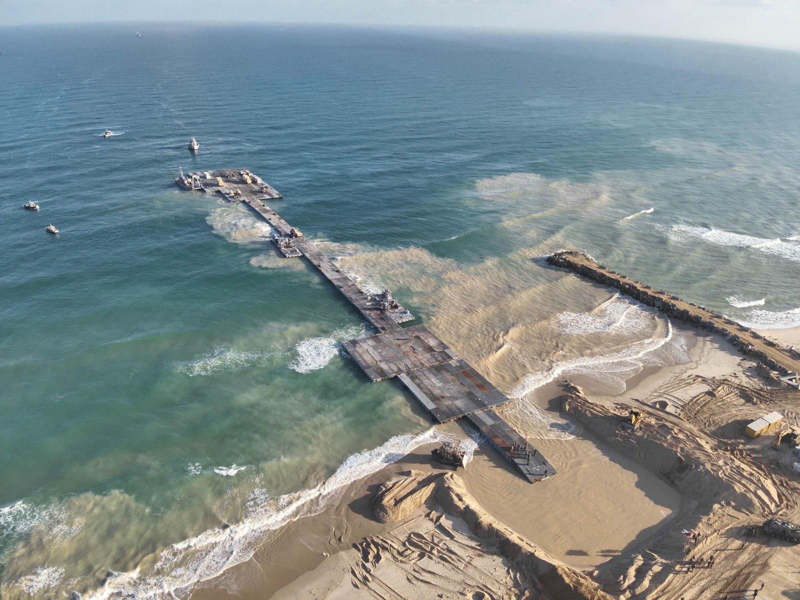 Ships are seen near a temporary floating pier built to receive humanitarian aid in the Gaza Strip in Gaza Beach, in this handout picture obtained by Reuters on May 18