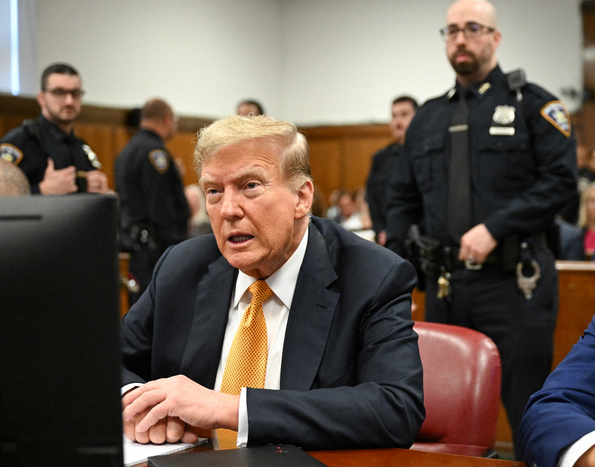 Former US President Donald Trump sits in court