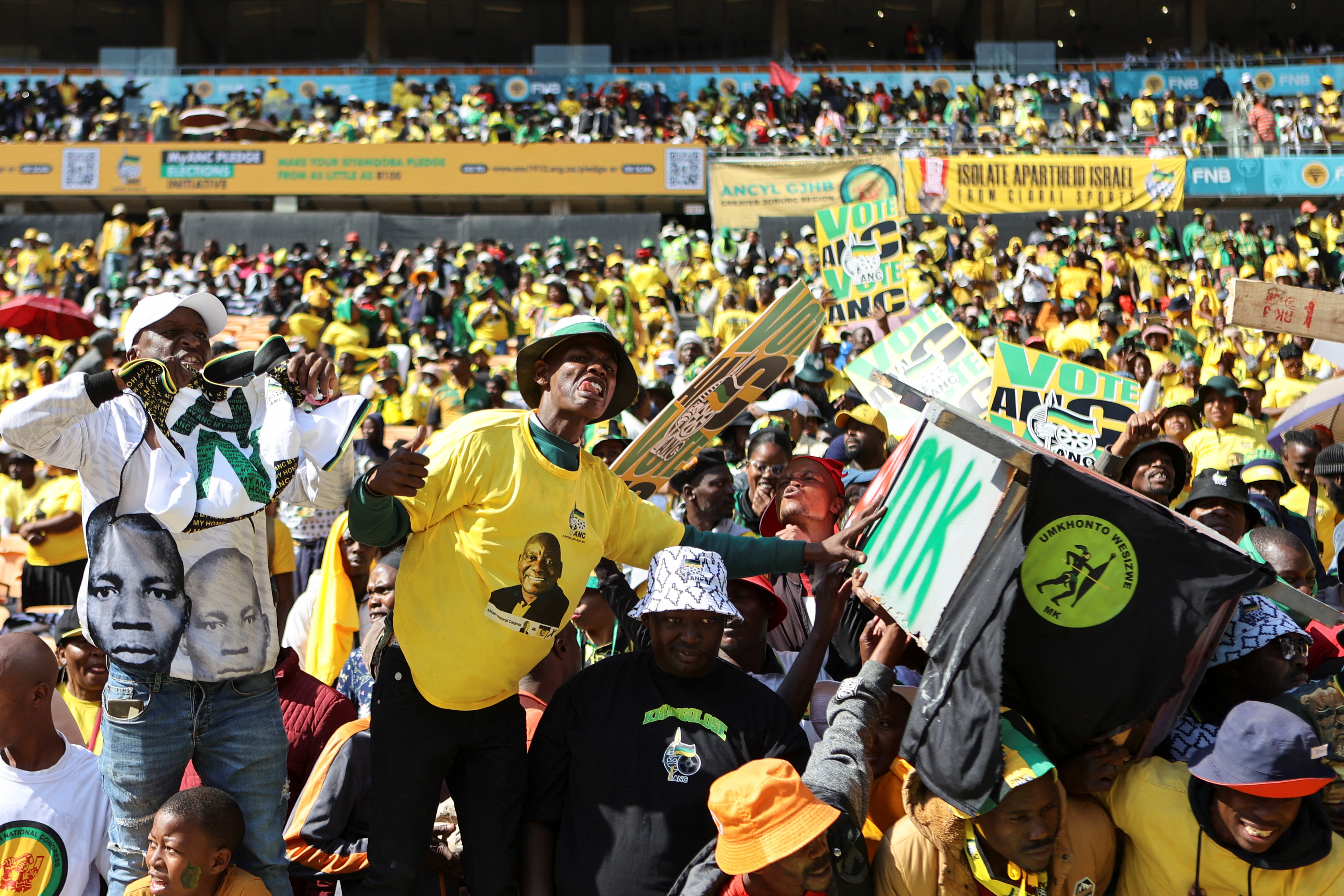 African National Congress (ANC) supporters gesture at a fake coffin that signifies the death of a rival political party during their final rally ahead of the upcoming election at FNB stadium in Johannesburg, South Africa, May 25, 2024. REUTERS/Alaister Russell